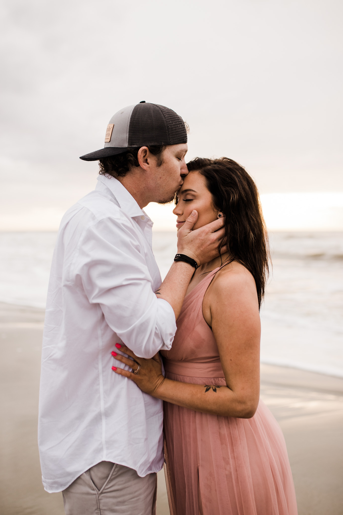A couple embraces at their Folly Beach engagement session