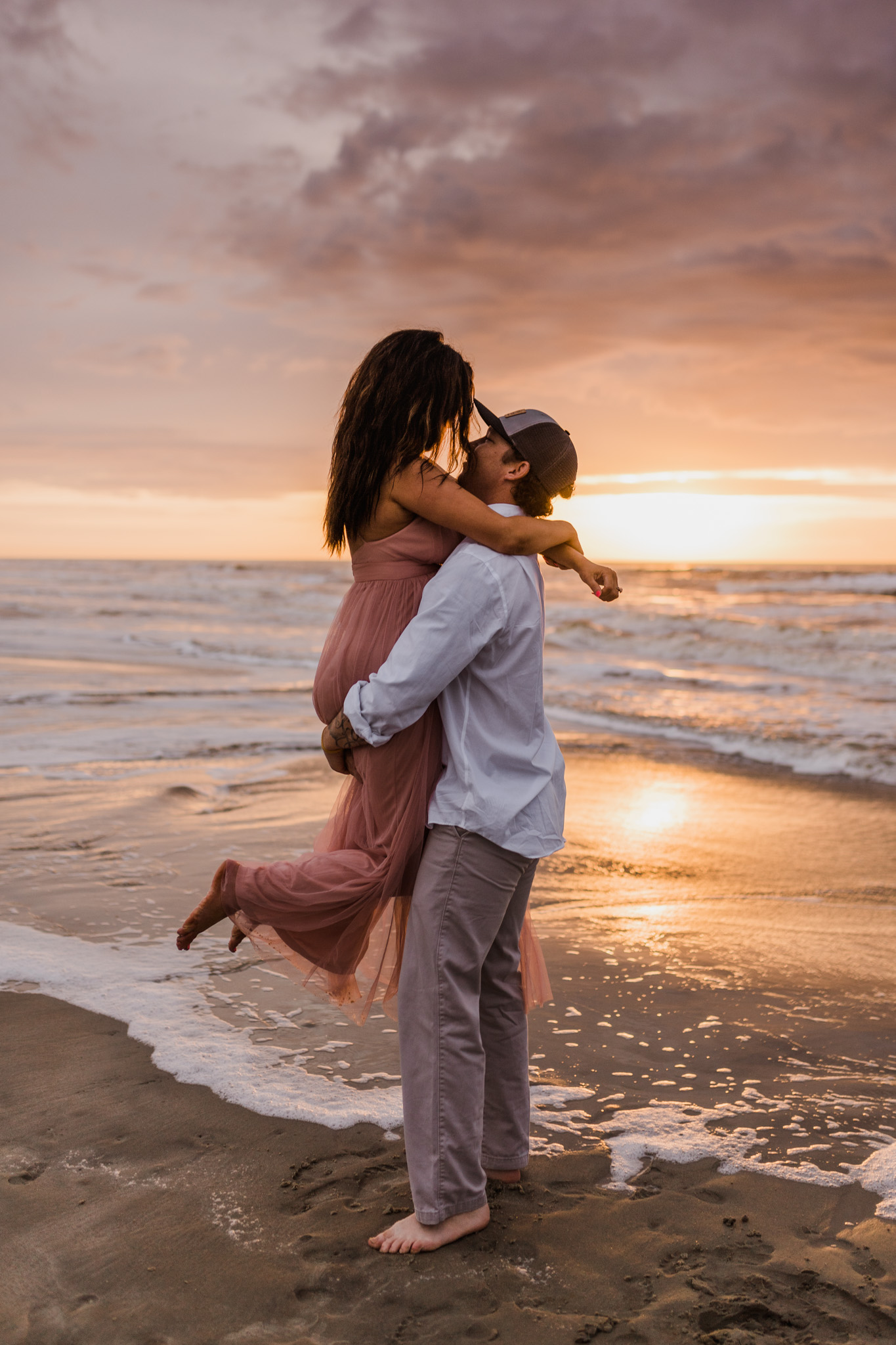 A couple slow dances in the waters at Folly Beach during their sunrise engagement session