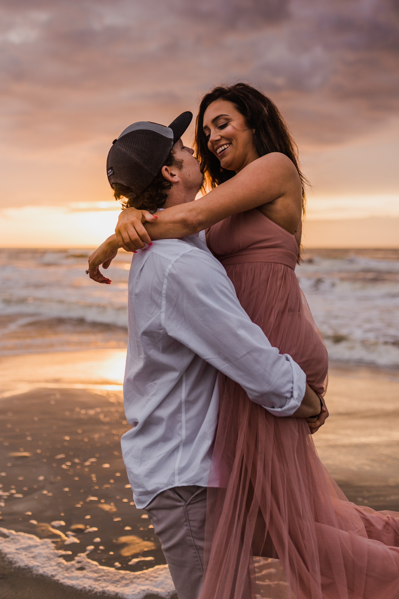 A couple slow dances in the waters at Folly Beach during their sunrise engagement session