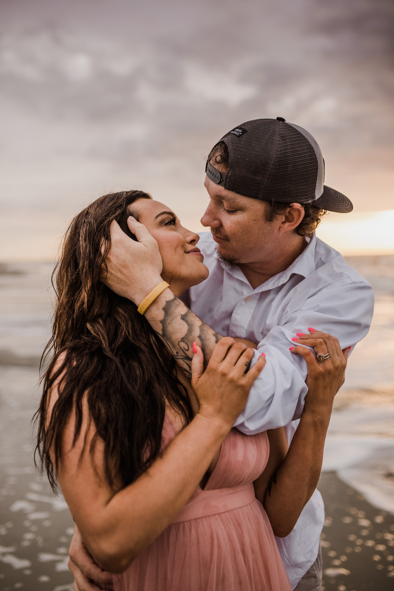 A couple embraces during their Folly Beach engagement session