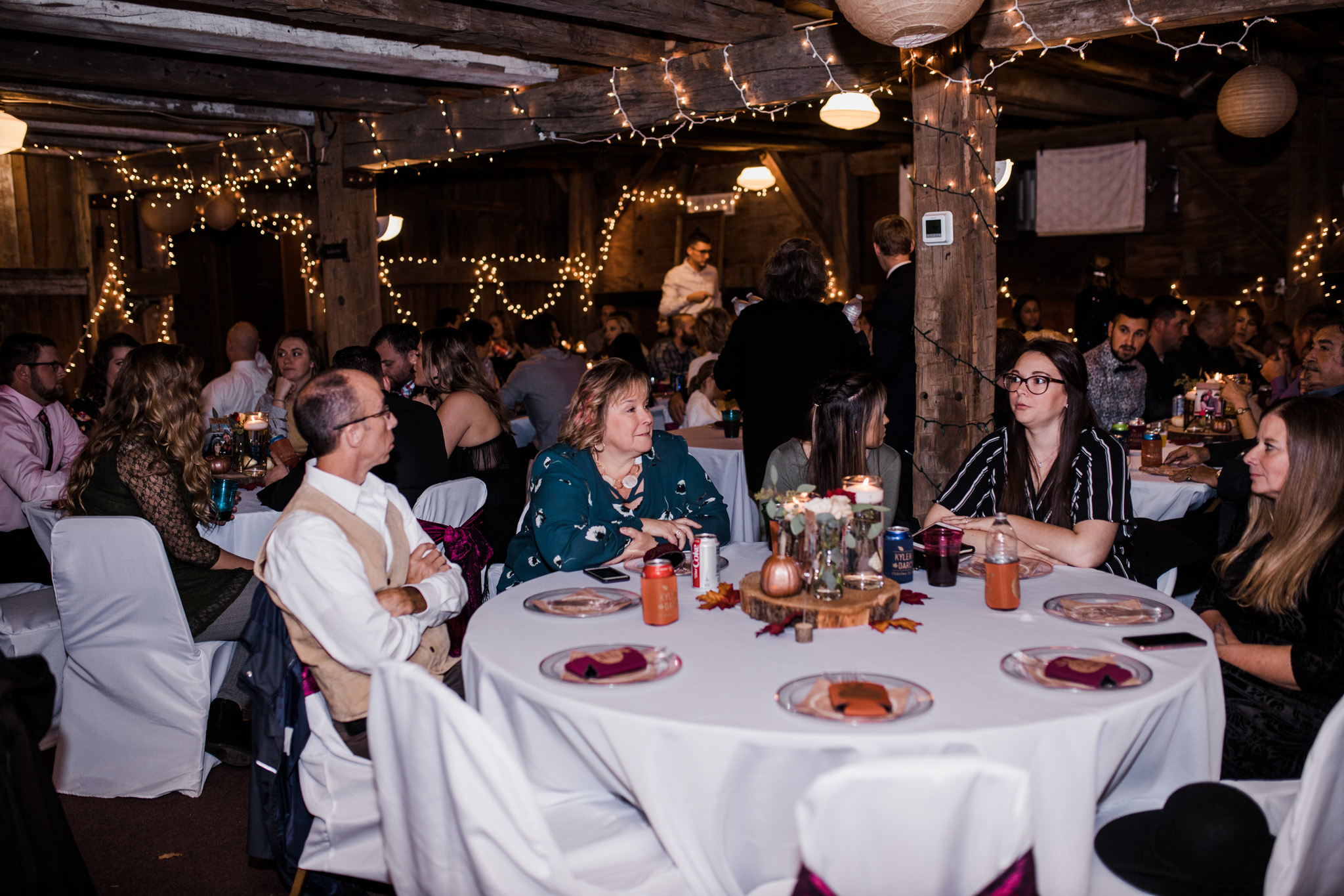 Guests at the reception during this fall ranch wedding.