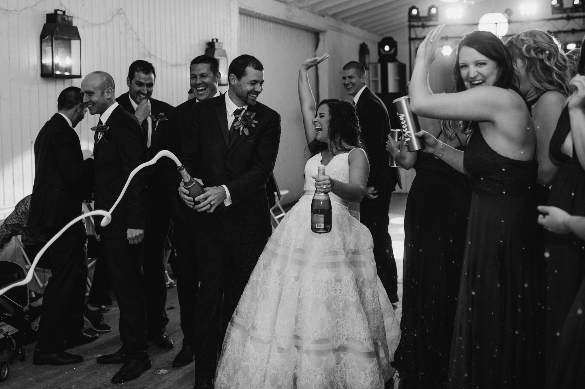 Popping champagne in celebration during an autumn wedding.