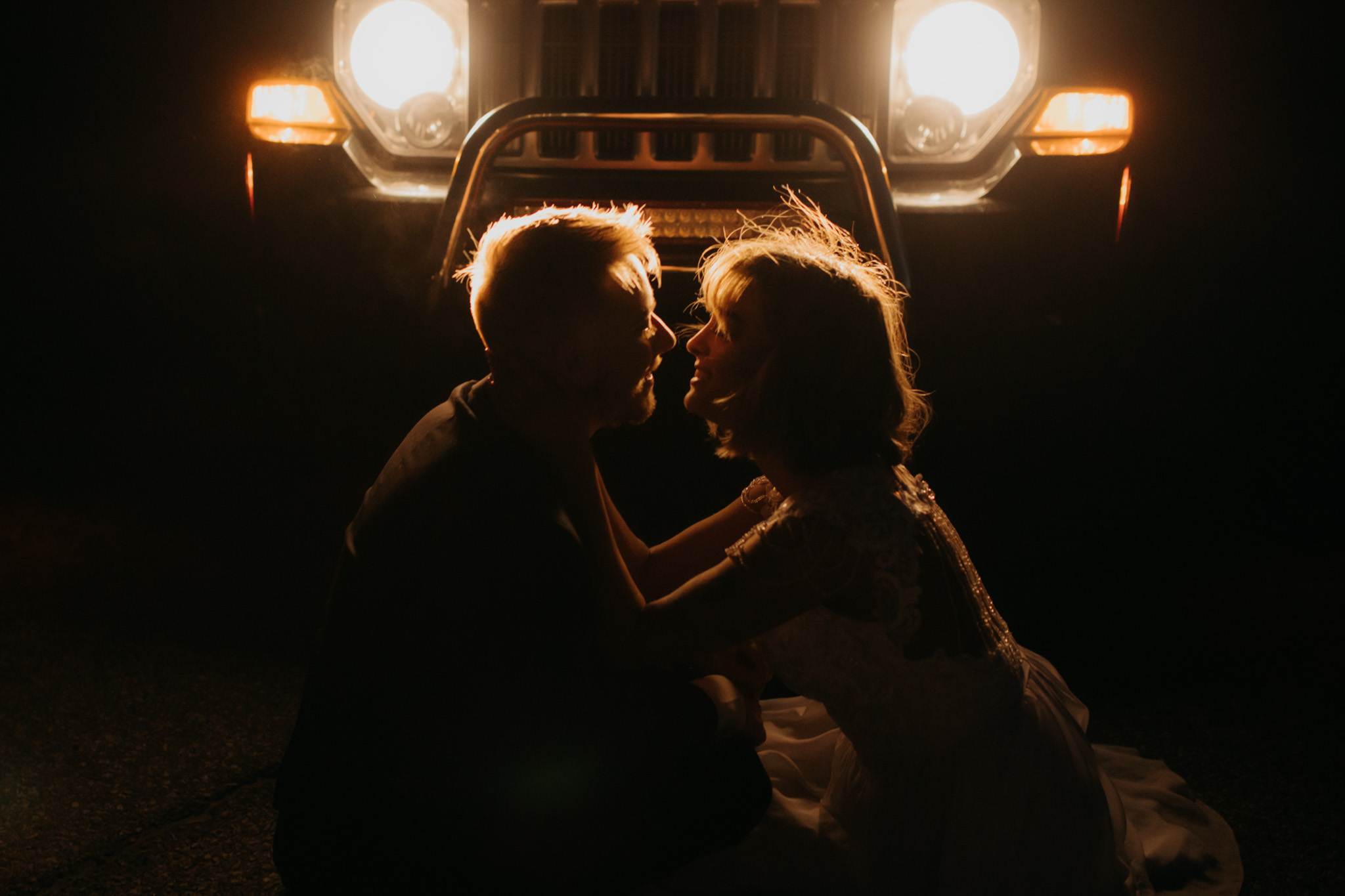 Intimate elopement photos with car headlights