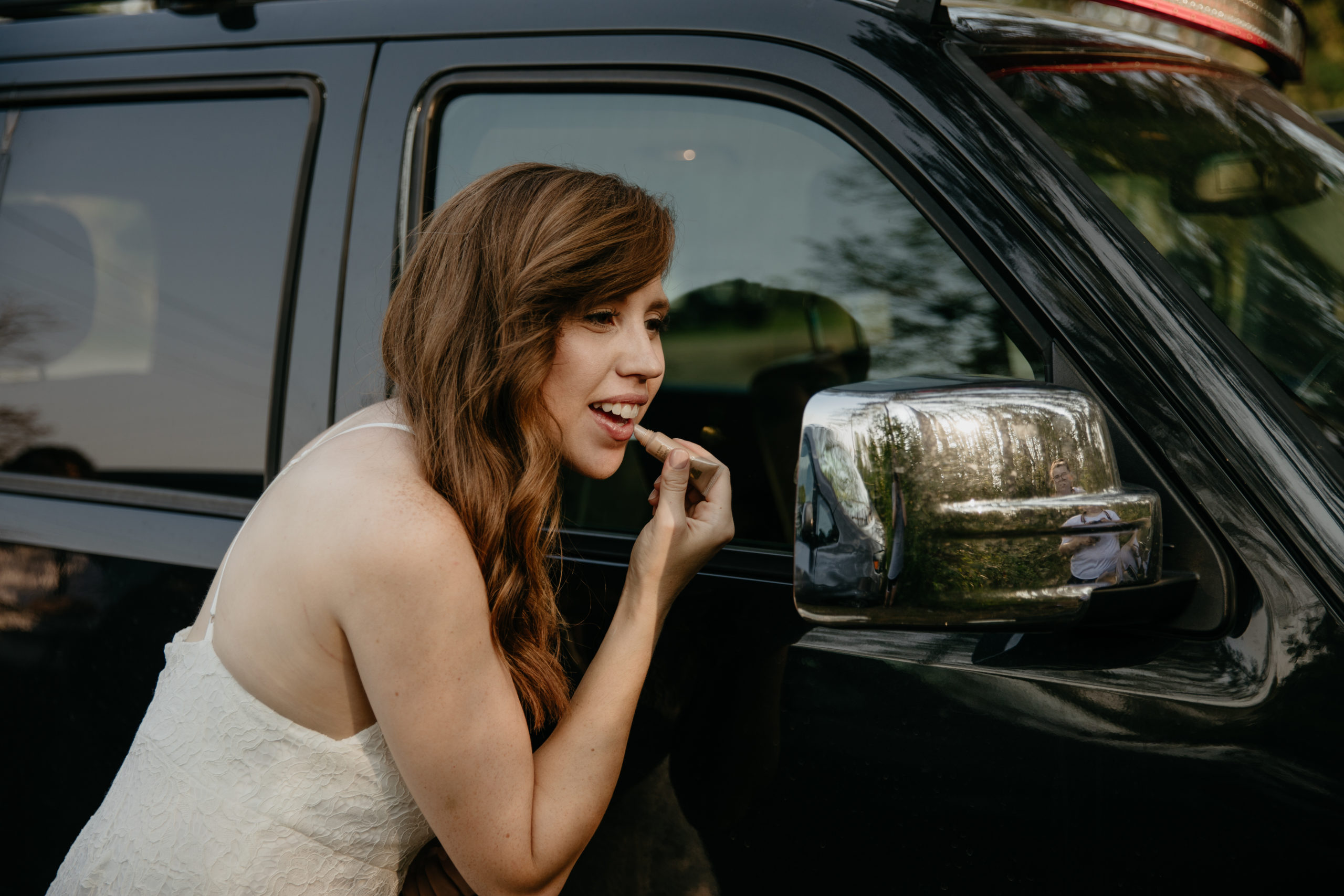The bride putting on lipstick before their intimate Michigan elopement
