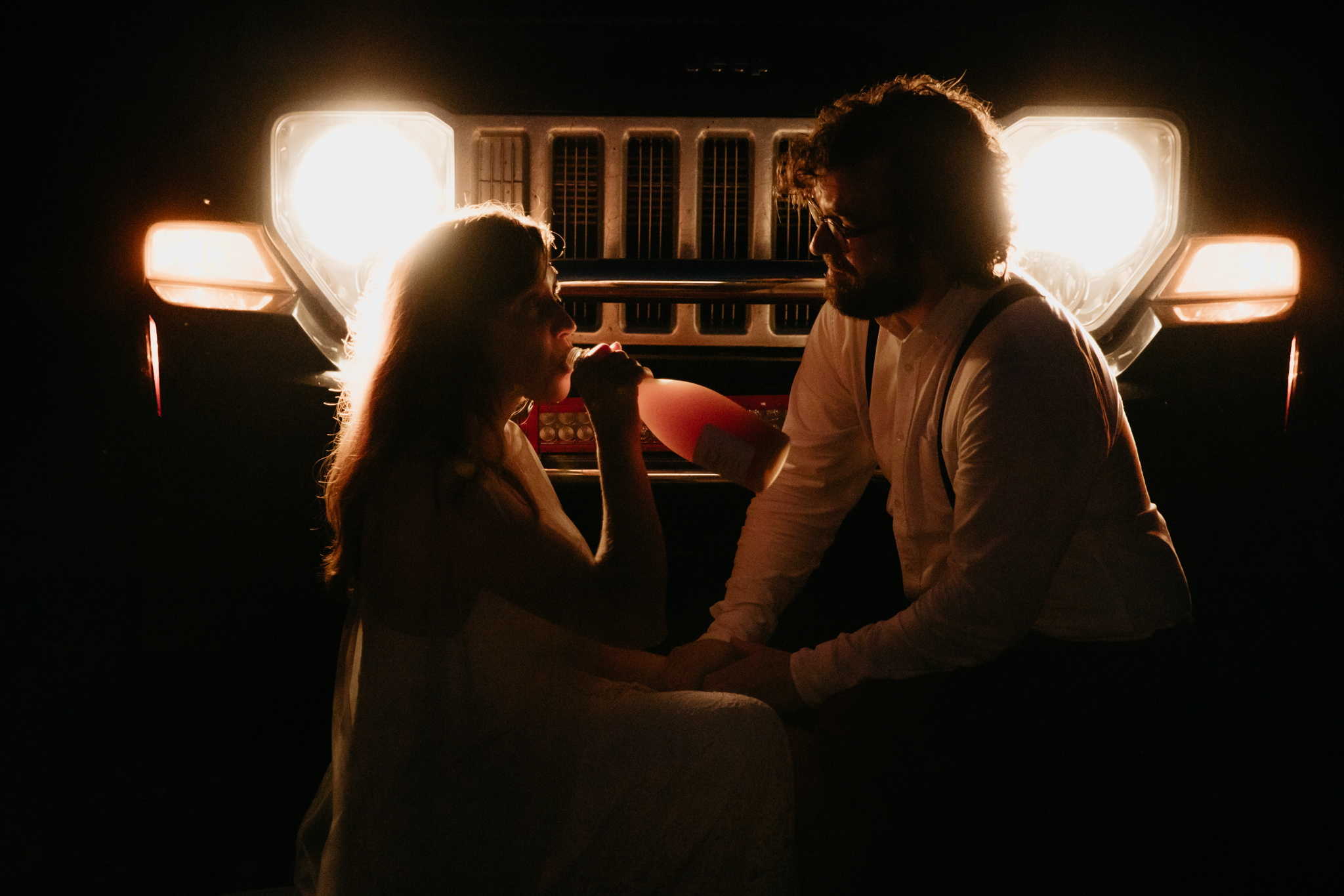 The prettiest Michigan Forest Elopement // Popping champagne in front of car headlights