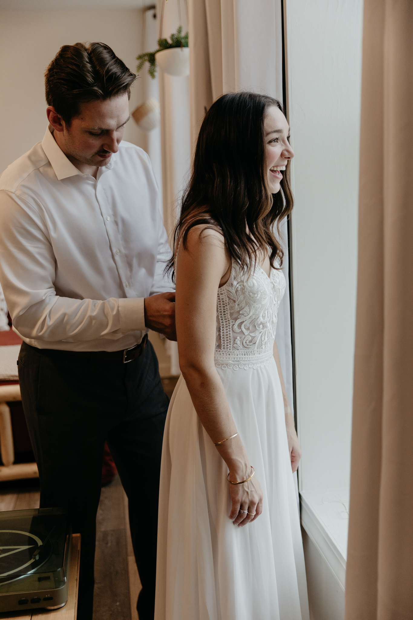 A couple getting ready at their Marquette apartment for their Black Rocks elopement