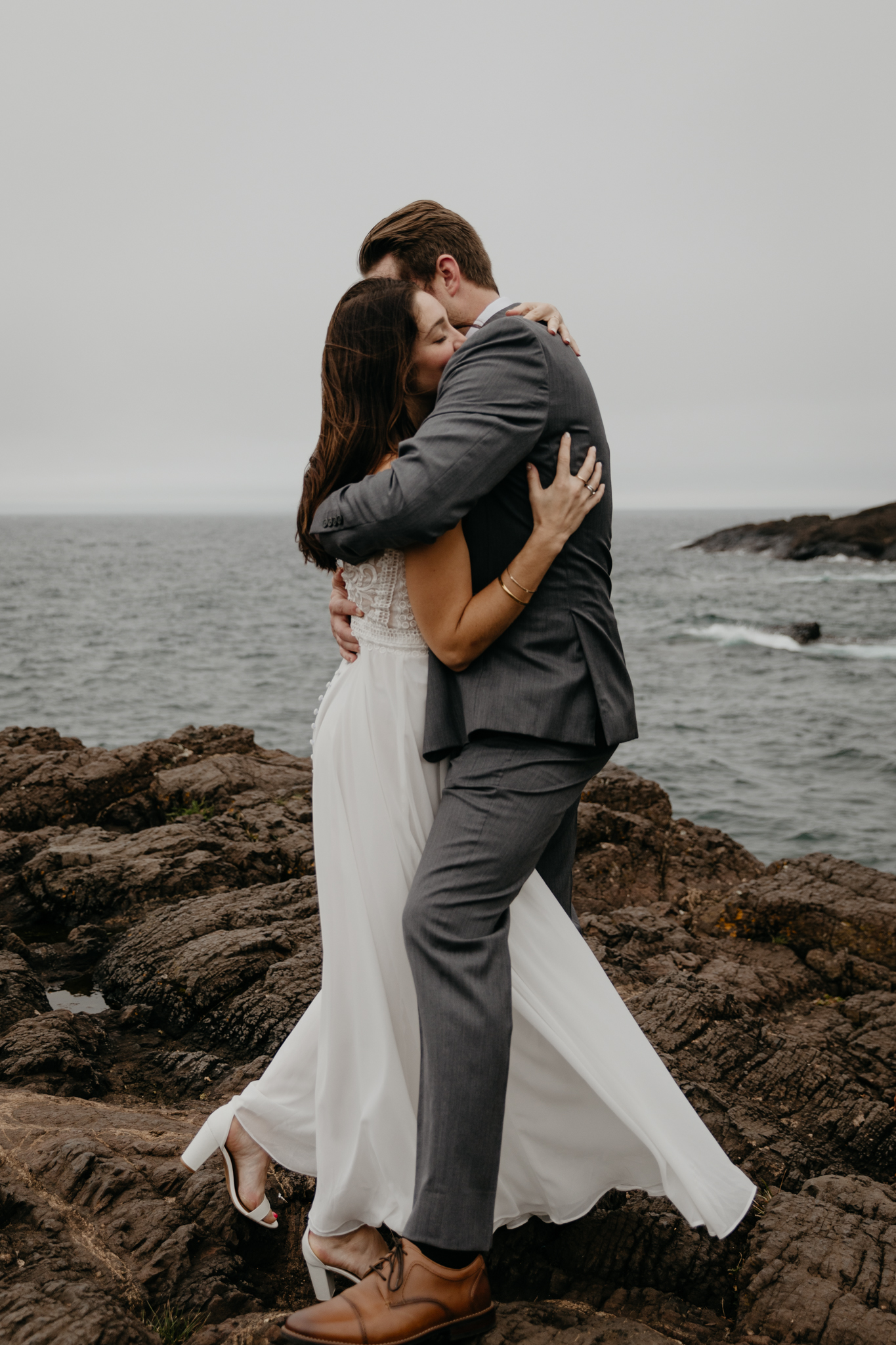 A couple hugging at Black Rocks, during their Presque Isle elopement