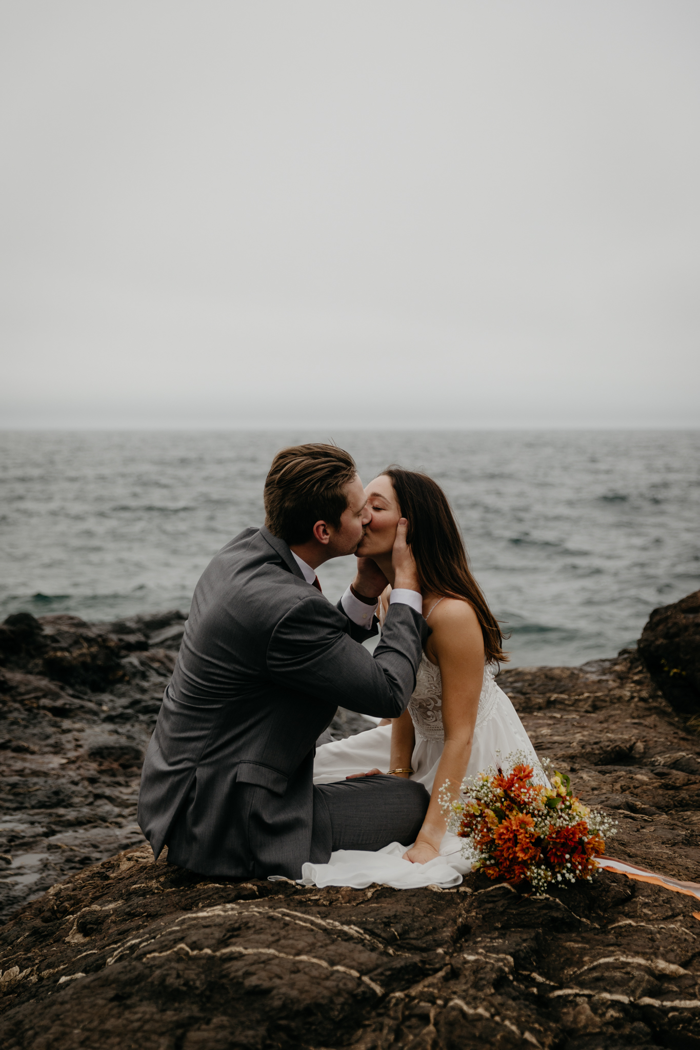 A couple embracing during their Black Rocks elopement in Michigan