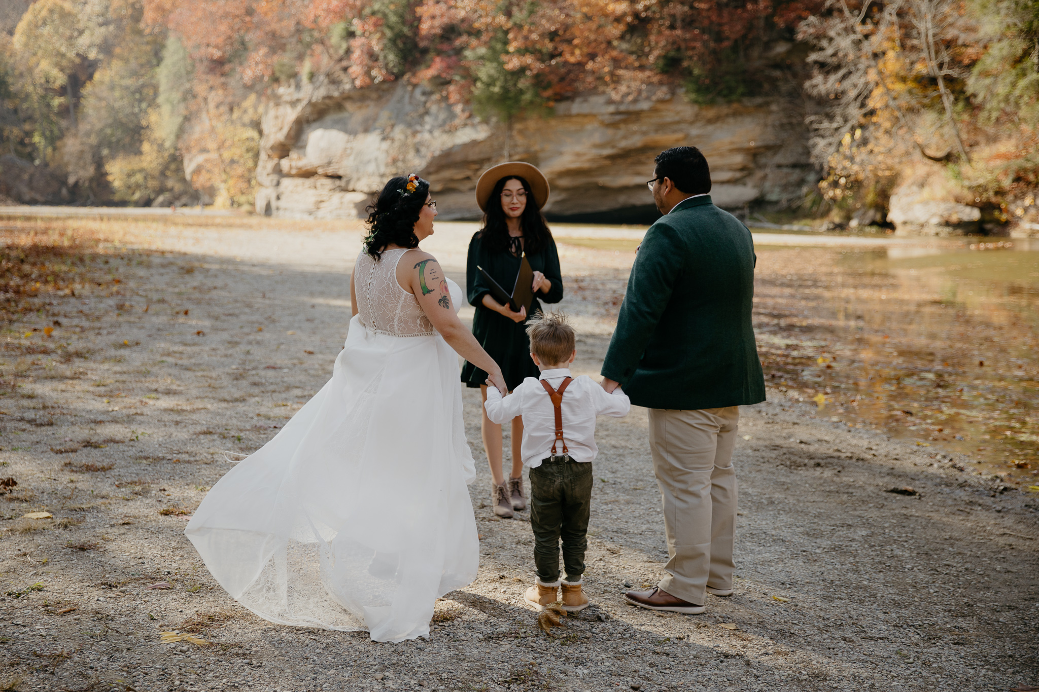 A couple eloping at Turkey Run Park in fall, exchanging vows at Sugar Creek.