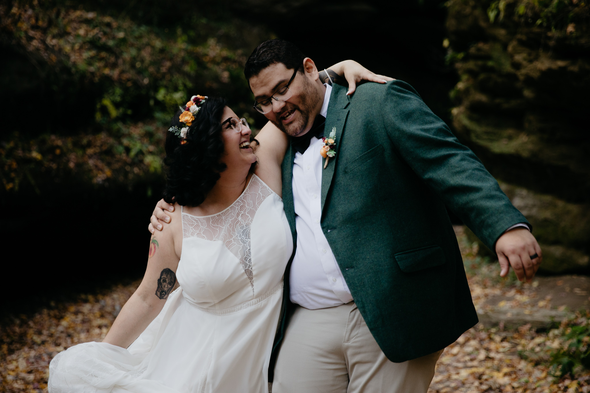 Bride and groom embracing in Bear Canyon in Turkey Run State Park during fall
