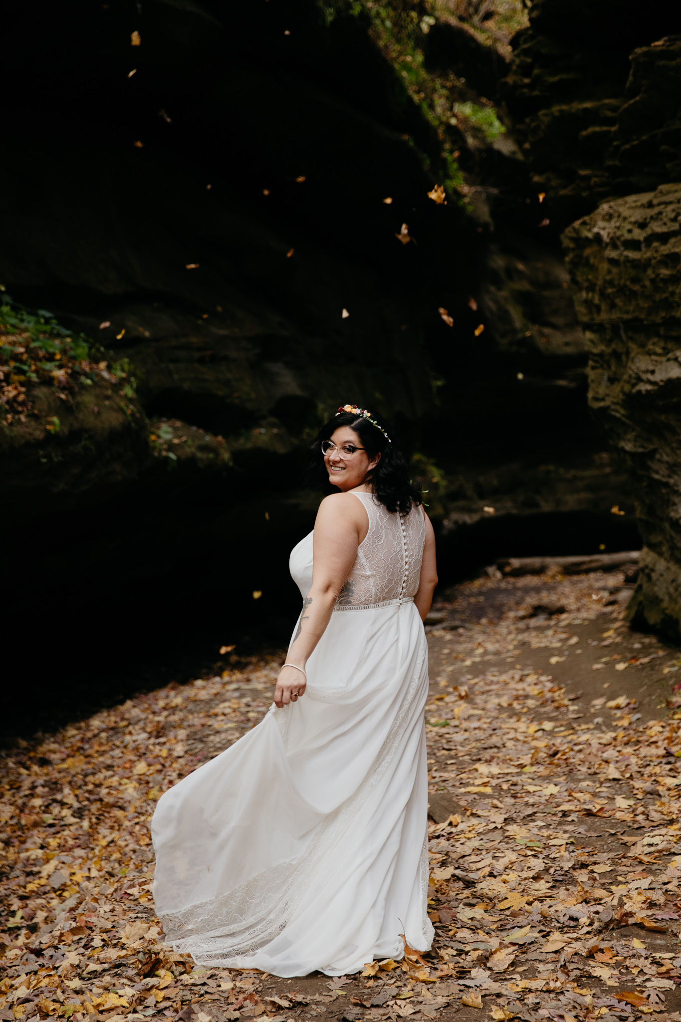 A bride dancing in fall leaves, within a canyon at Turkey Run State Park, Indiana
