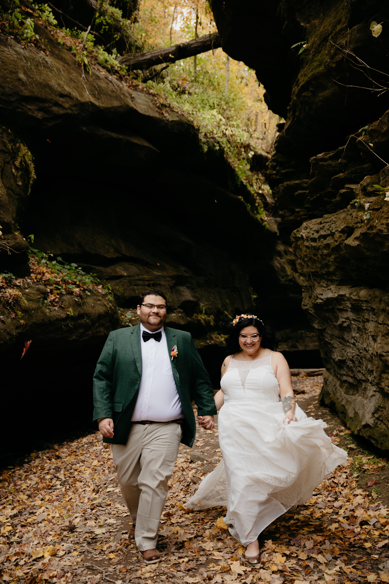 Bride and groom kissing in the middle of a rock canyon in fall at Turkey Run State Park