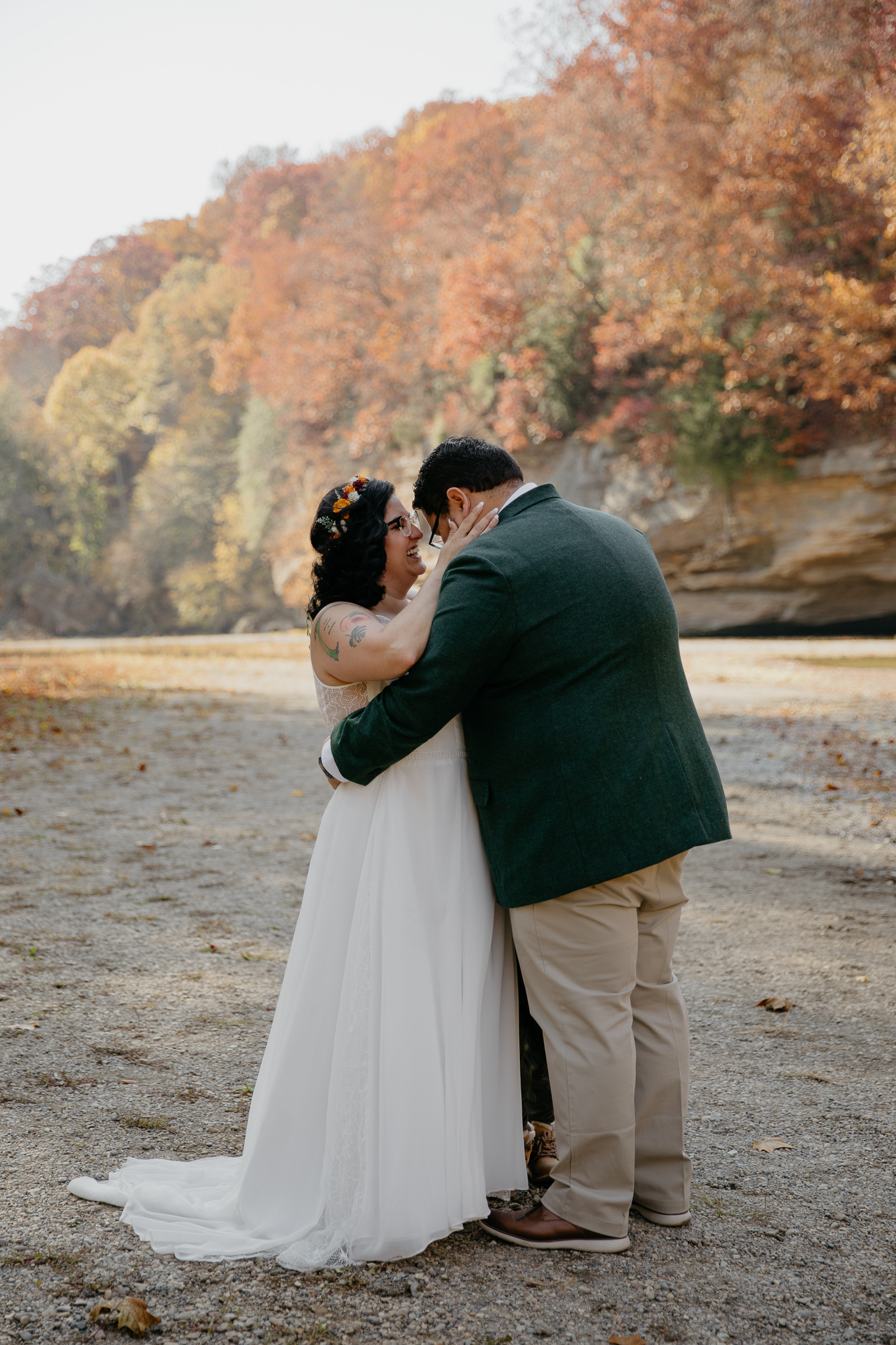A groom and bride share their first kiss at their fall elopement in Turkey Run Park