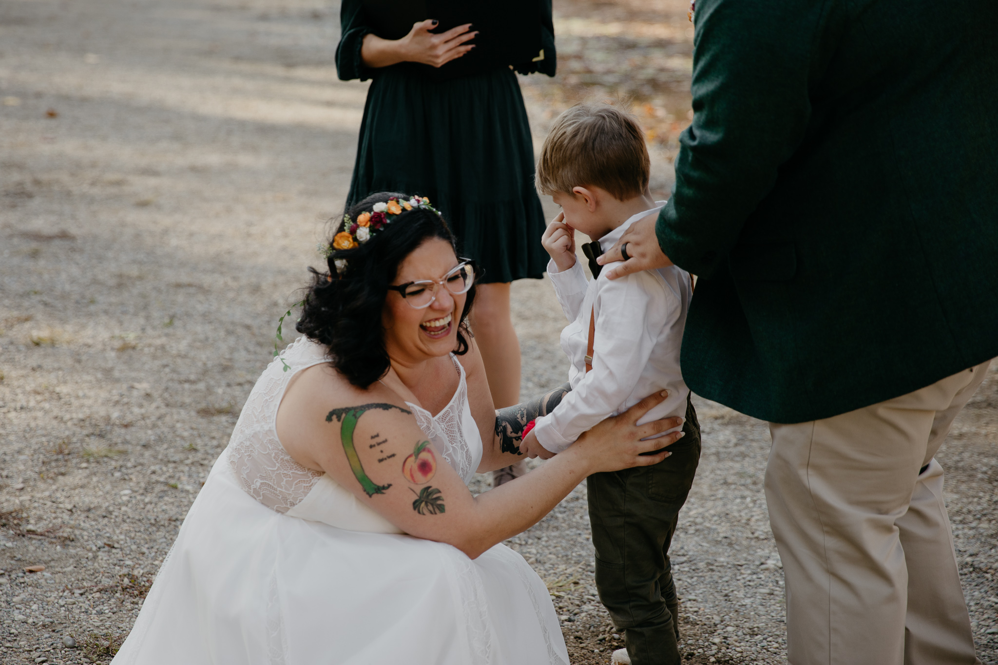 A bride laughs with her son after their fall elopement ceremony in Turkey Run Park
