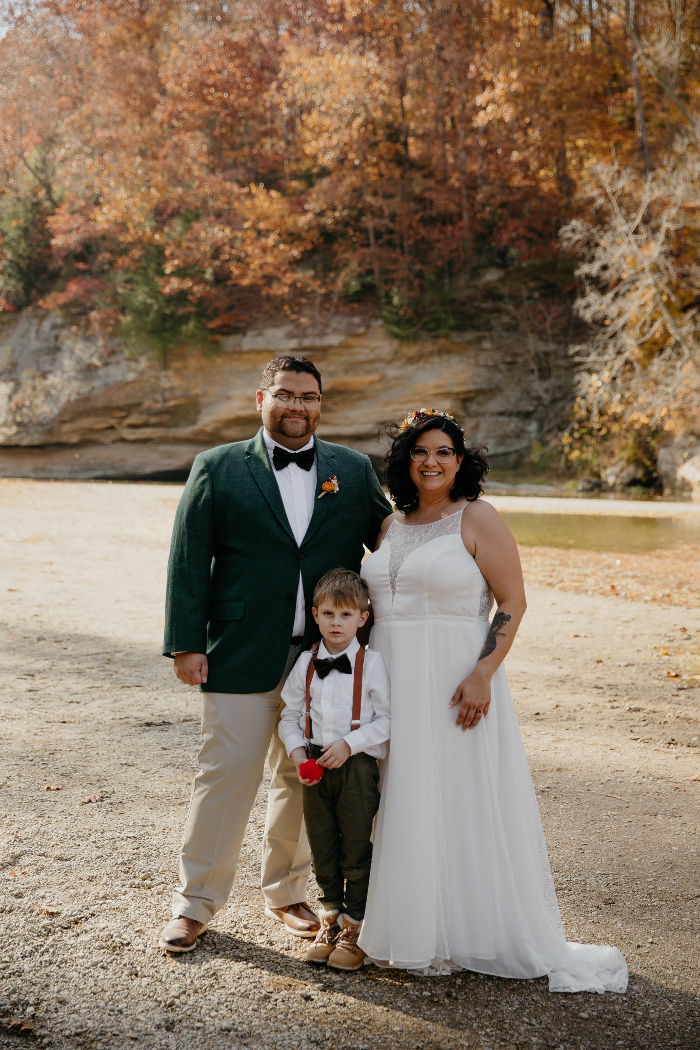 A groom and bride share a moment with their son after their intimate elopement ceremony at Turkey Run State Park