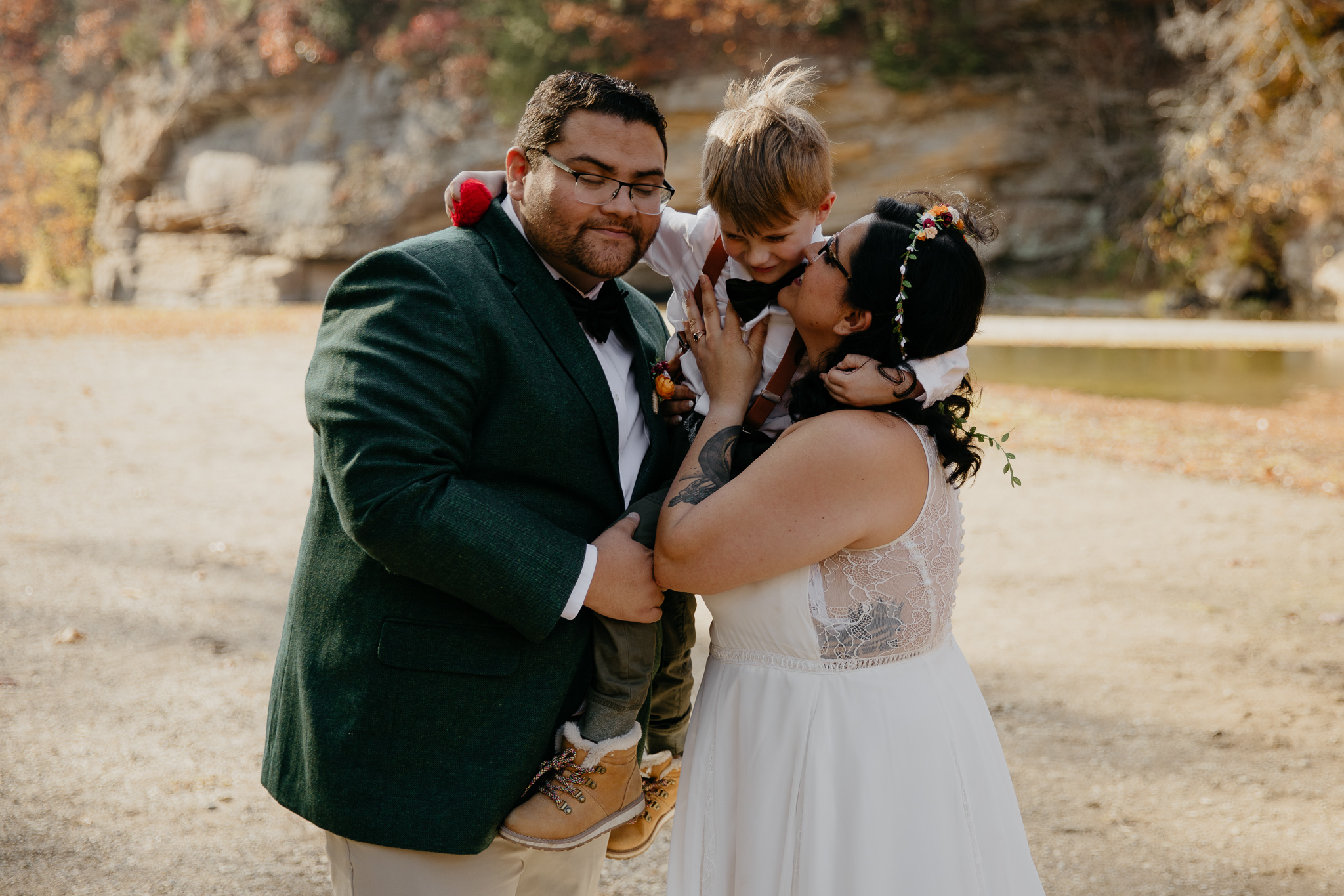 A groom and bride share a moment with their son after their intimate elopement ceremony at Turkey Run State Park