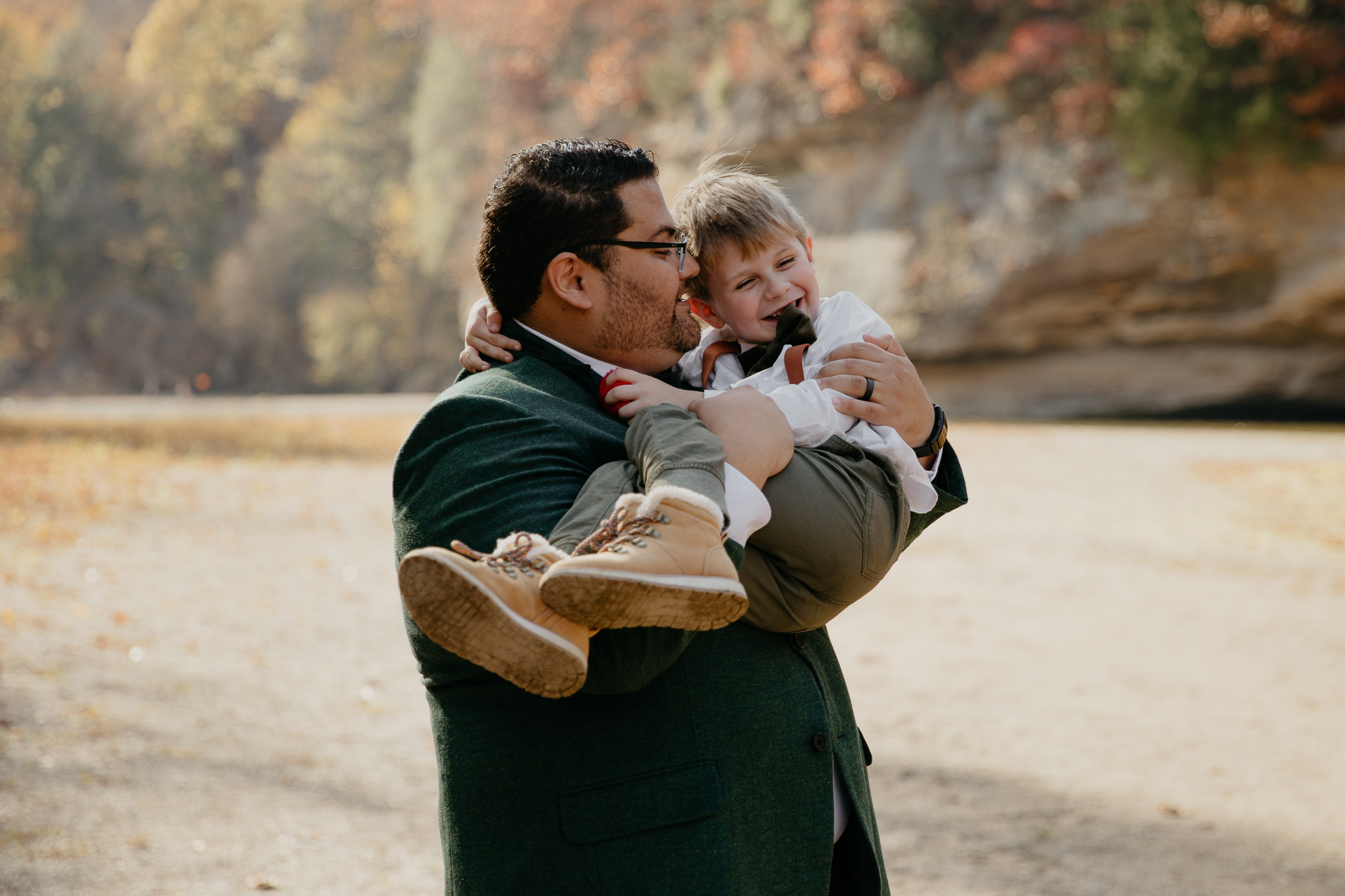 A groom shares a moment with their son after their intimate elopement ceremony at Turkey Run State Park