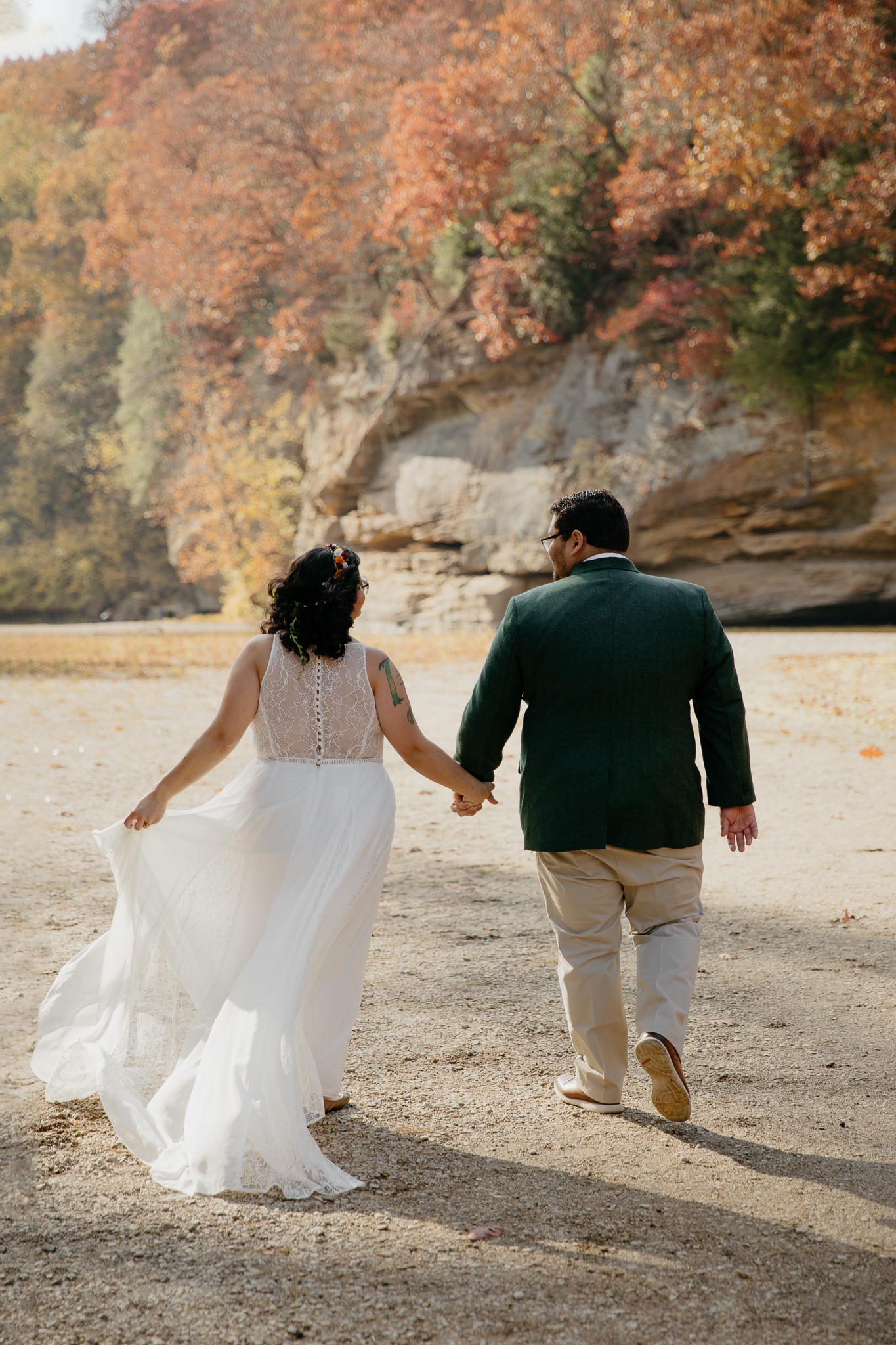 Groom and bride walking towards the canyons of Turkey Run State Park