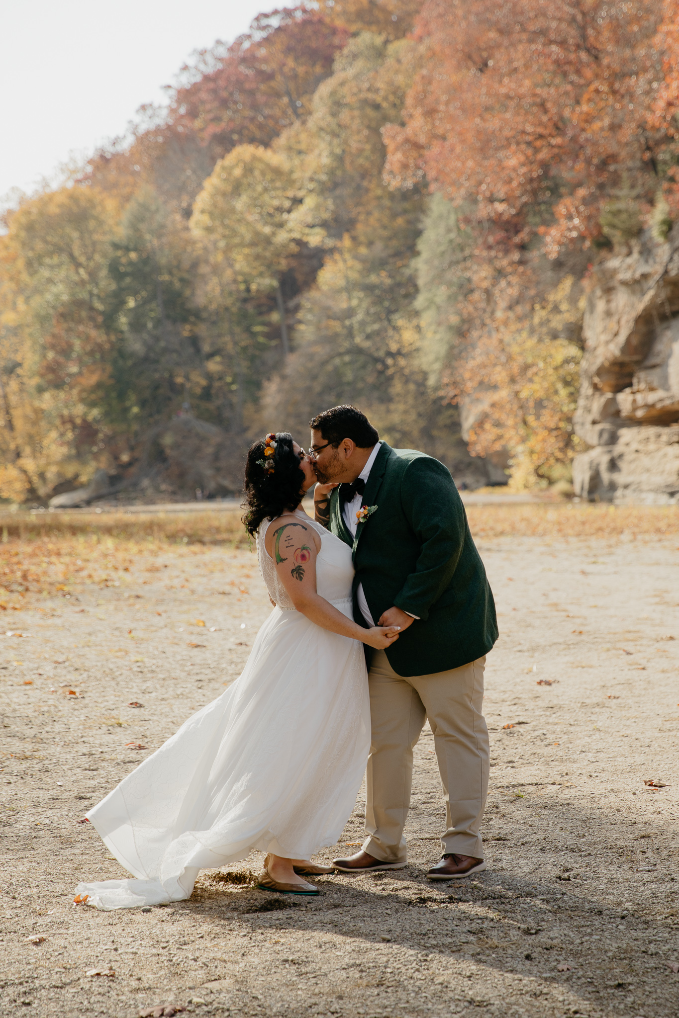 A bride and groom kissing by Sugar Creek, Turkey Run, after their elopement ceremony