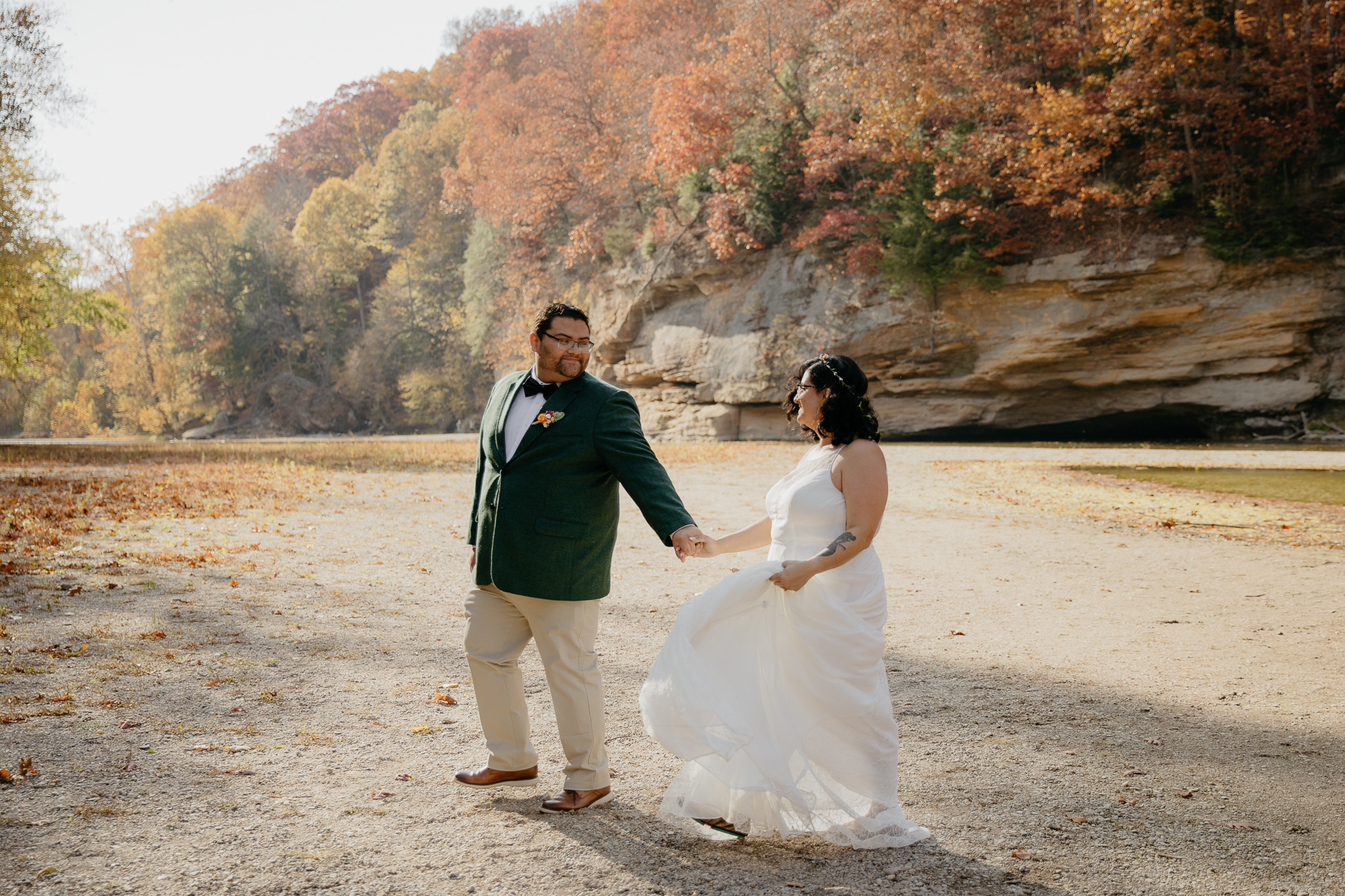 A bride and groom walking along Sugar Creek, Turkey Run, after their elopement ceremony