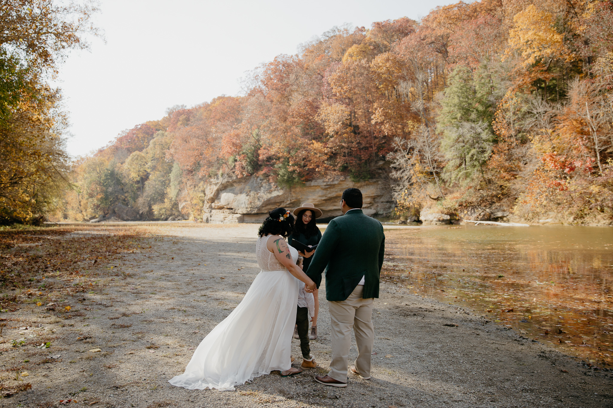 A couple eloping at Turkey Run Park in fall, exchanging vows at Sugar Creek.
