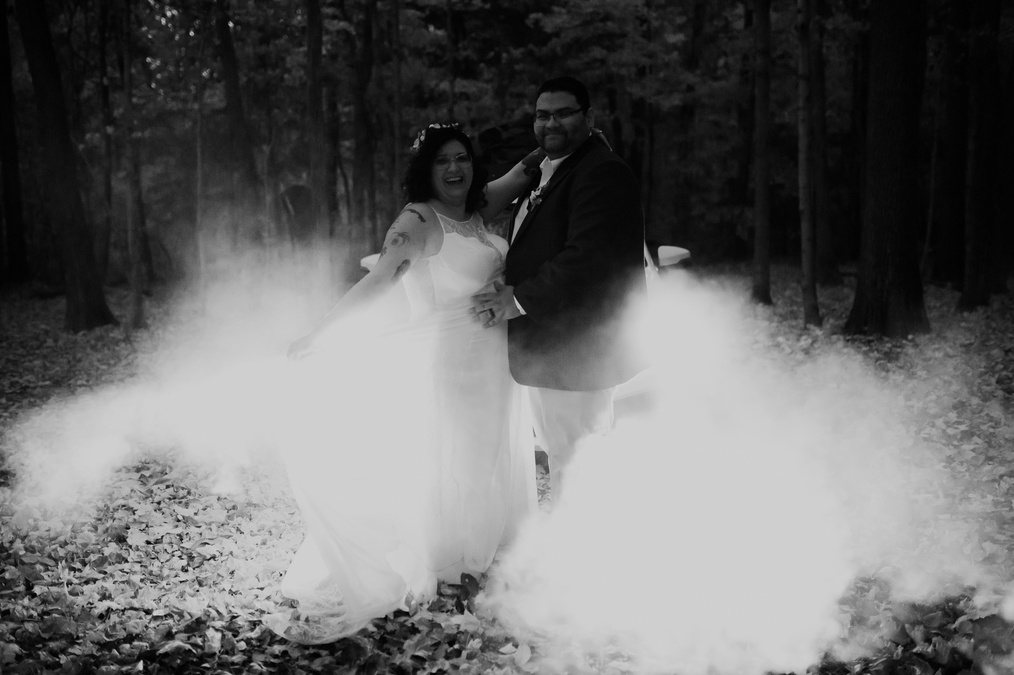 Bride and groom snuggle by a campfire during their fall elopement at Turkey Run State Park
