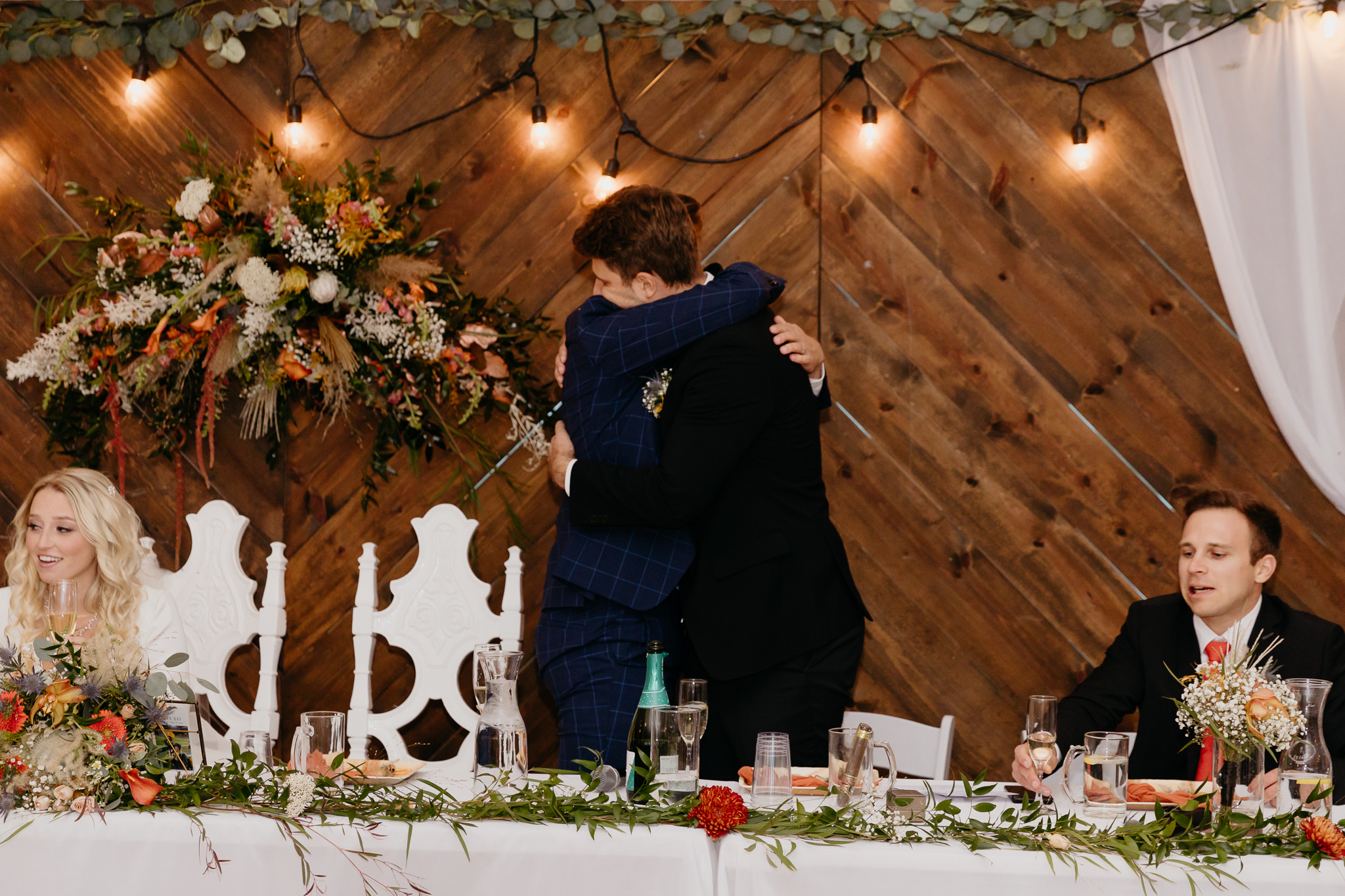 Groom hugs best man after wedding speech