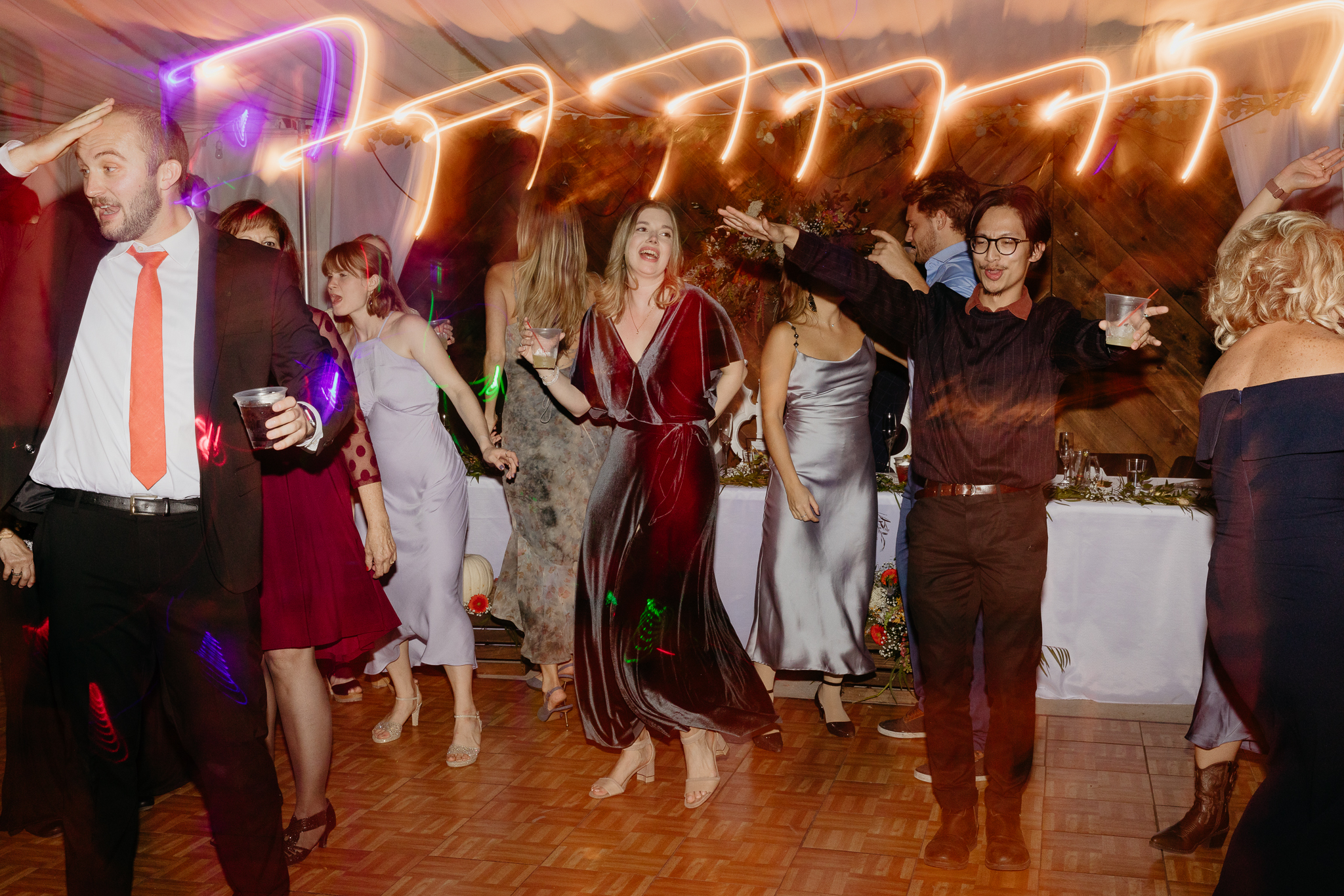 Bride and groom dancing on the dance floor with light trails at their Chicago outdoor tent wedding