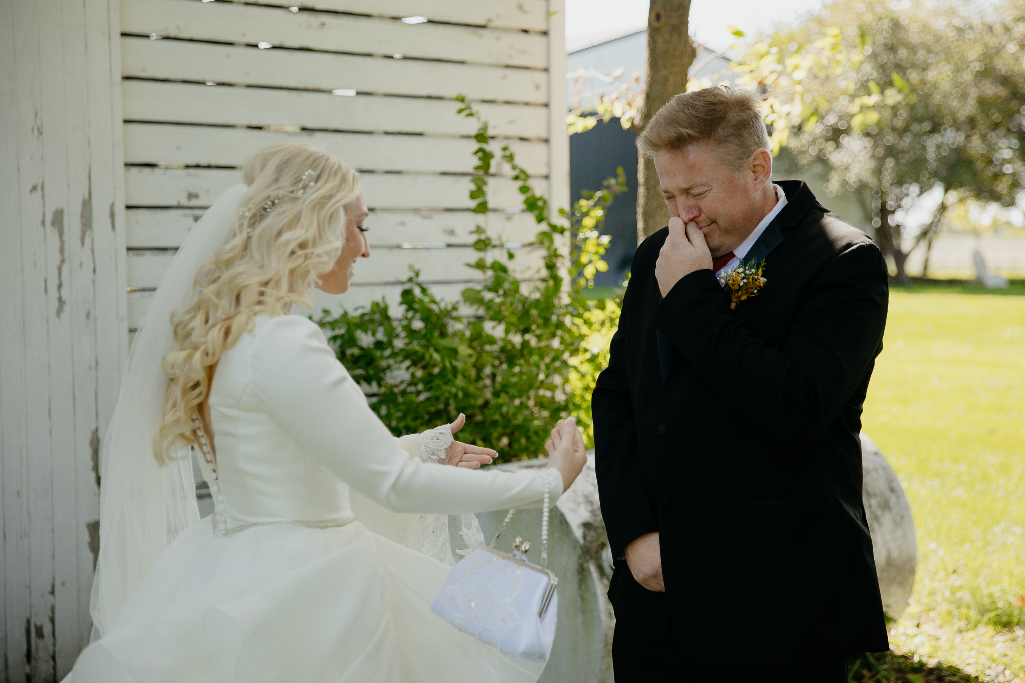 Bride taps father on shoulder for the first look at her fall wedding at Northfork Farm