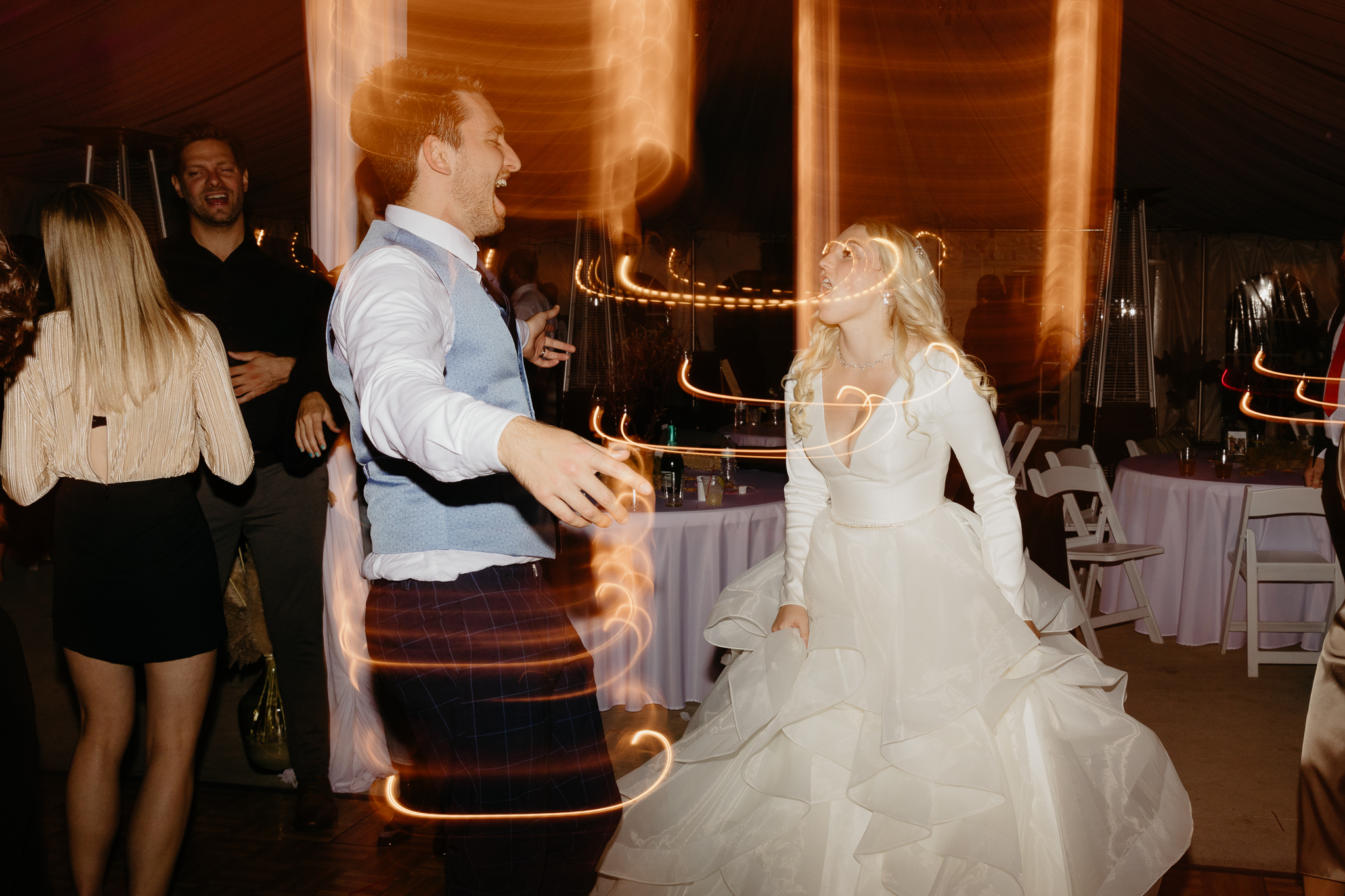 Bride and groom dancing on the dance floor with light trails at their Chicago outdoor wedding