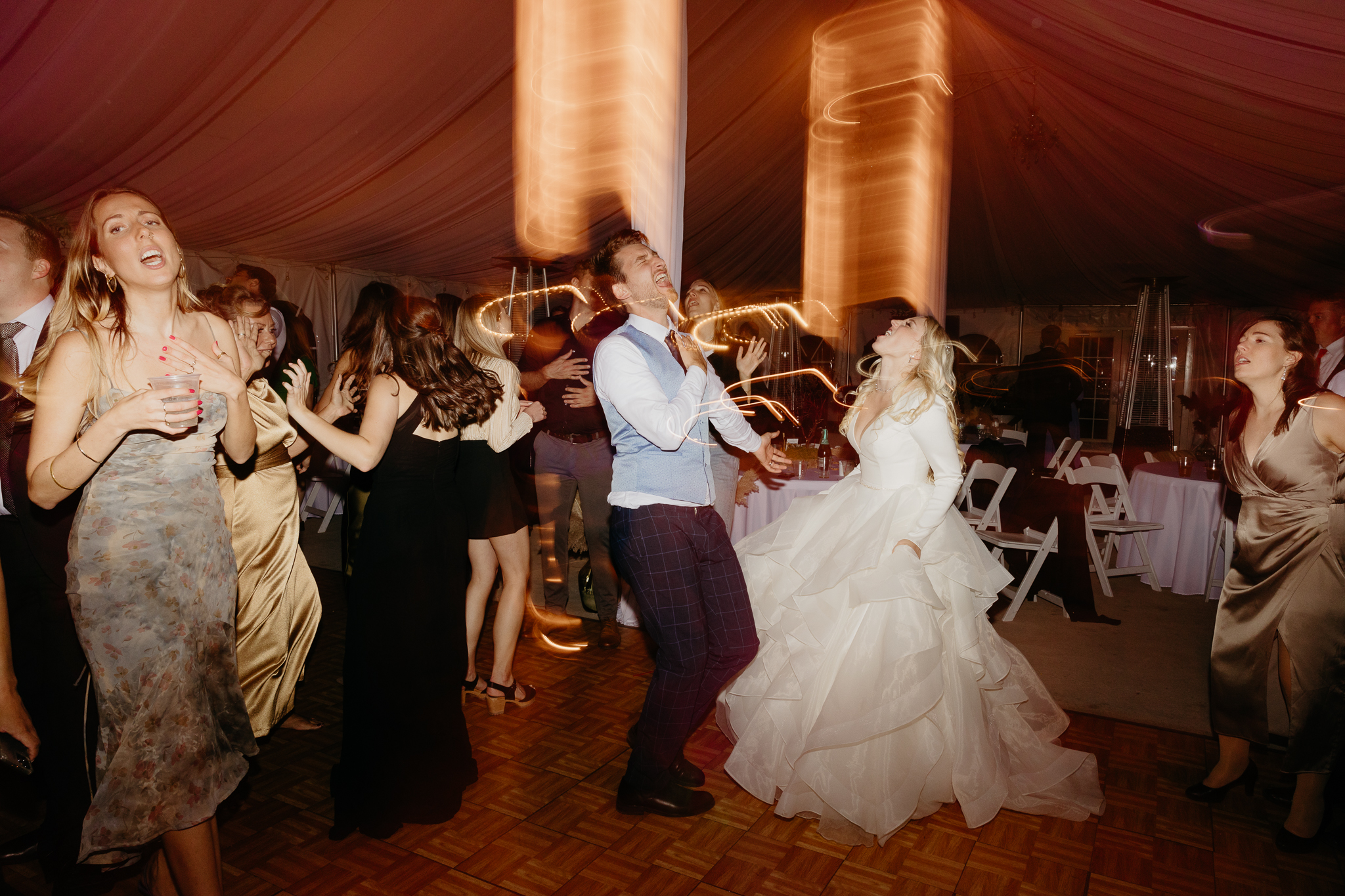 Bride and groom dancing on the dance floor with light trails at their Chicago outdoor wedding