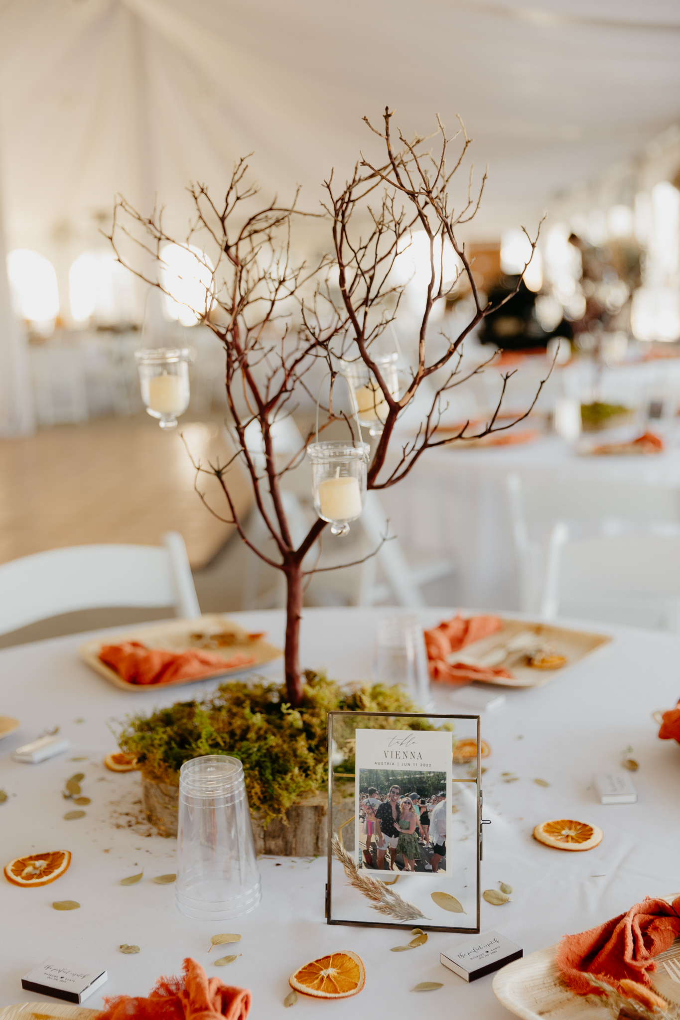 Wedding decorations and tables in a large white tent