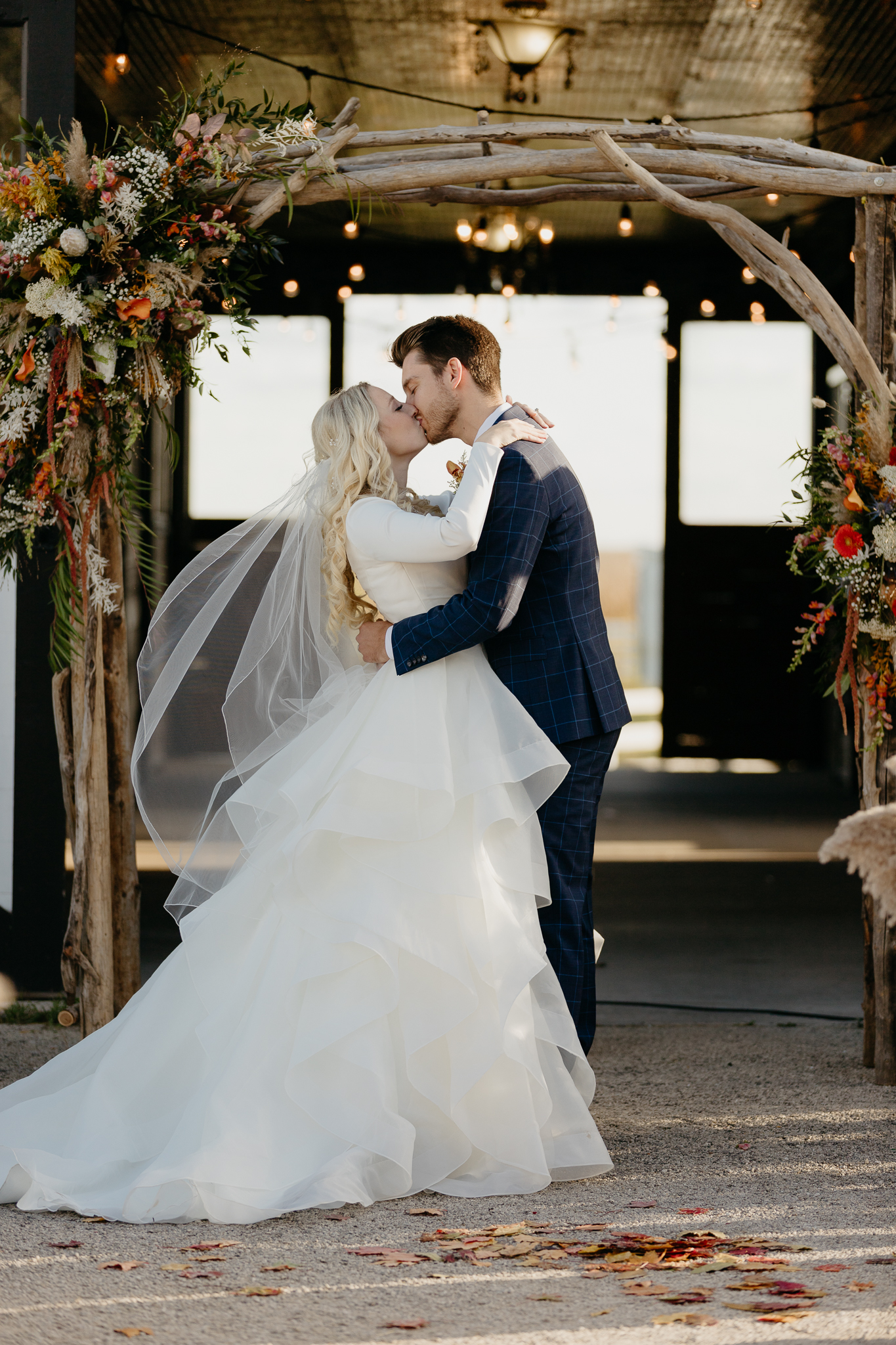 Bride and Groom's first kiss at the altar of their outdoor horse farm wedding in Oswego