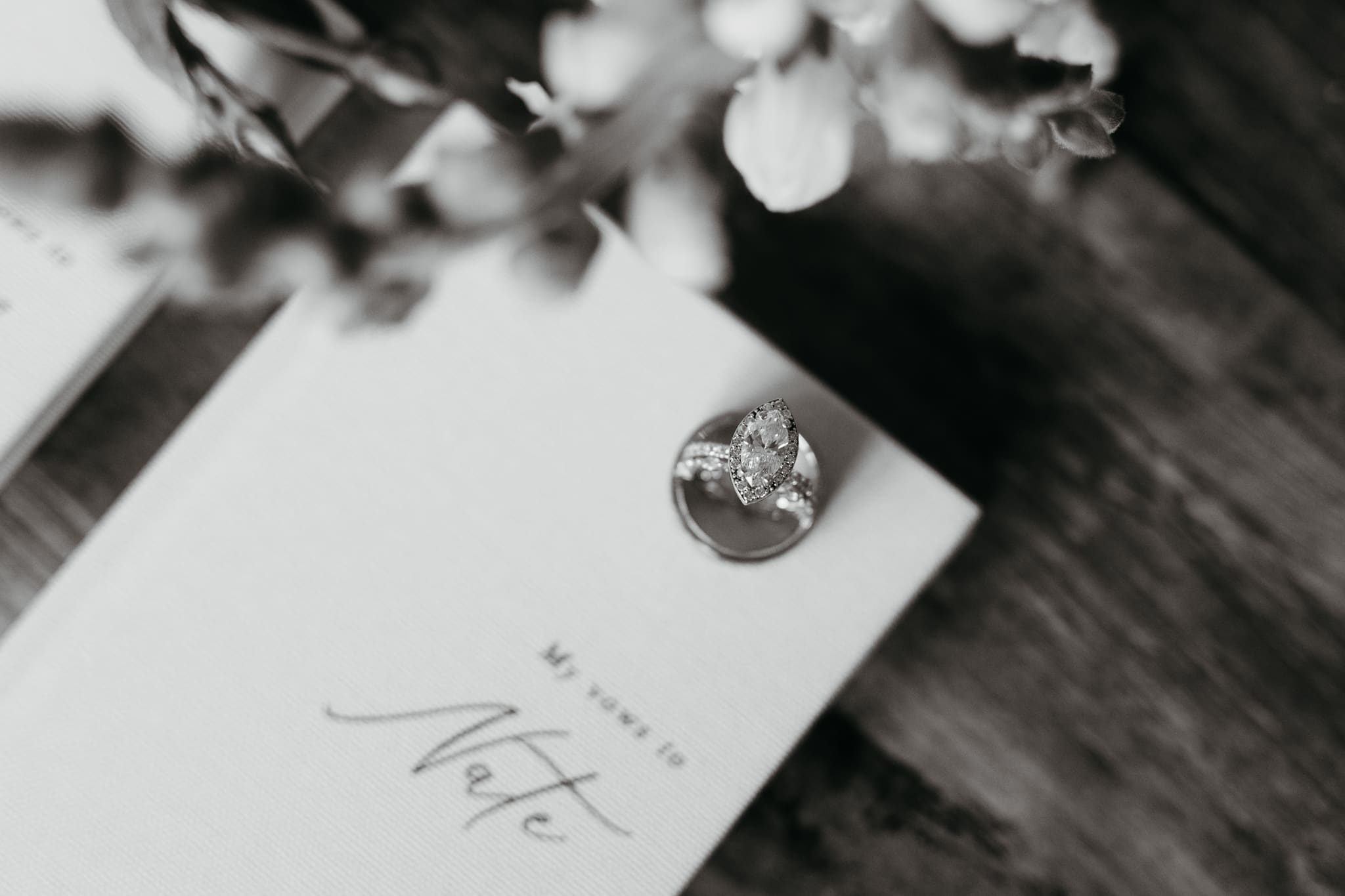 Wedding vow books with wedding rings and bouquet of flowers for a beach elopement at Warren Dunes