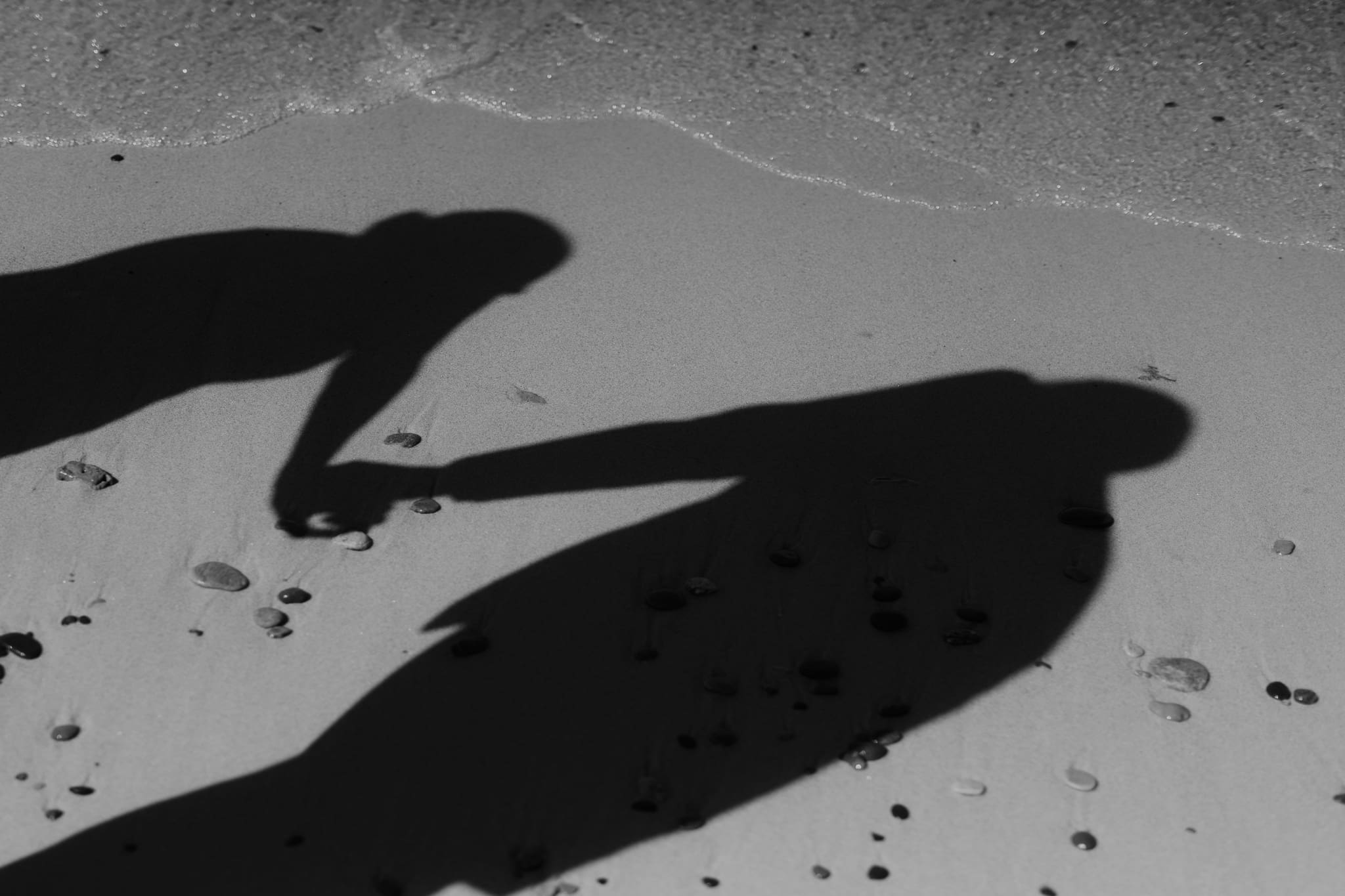 Bride and groom running along the shore of Lake Michigan during their elopement at Warren Dunes State Park