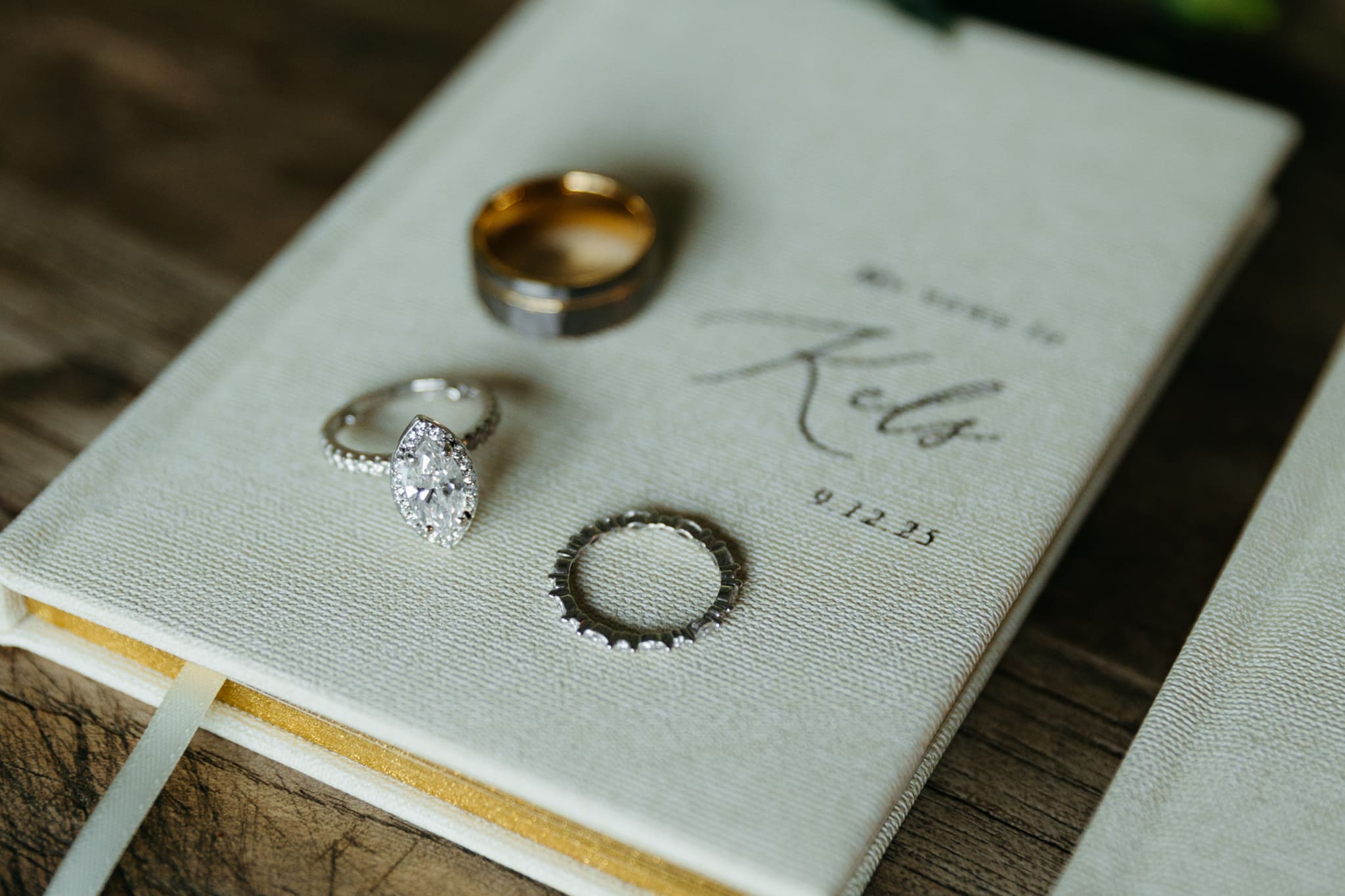 Wedding vow books with wedding rings and bouquet of flowers for a beach elopement at Warren Dunes