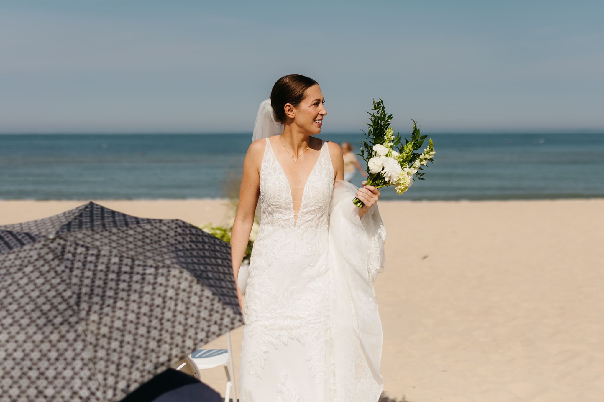 Family and friends hang out and talk on the beach at Warren Dunes State Park, while waiting for a wedding ceremony to begin