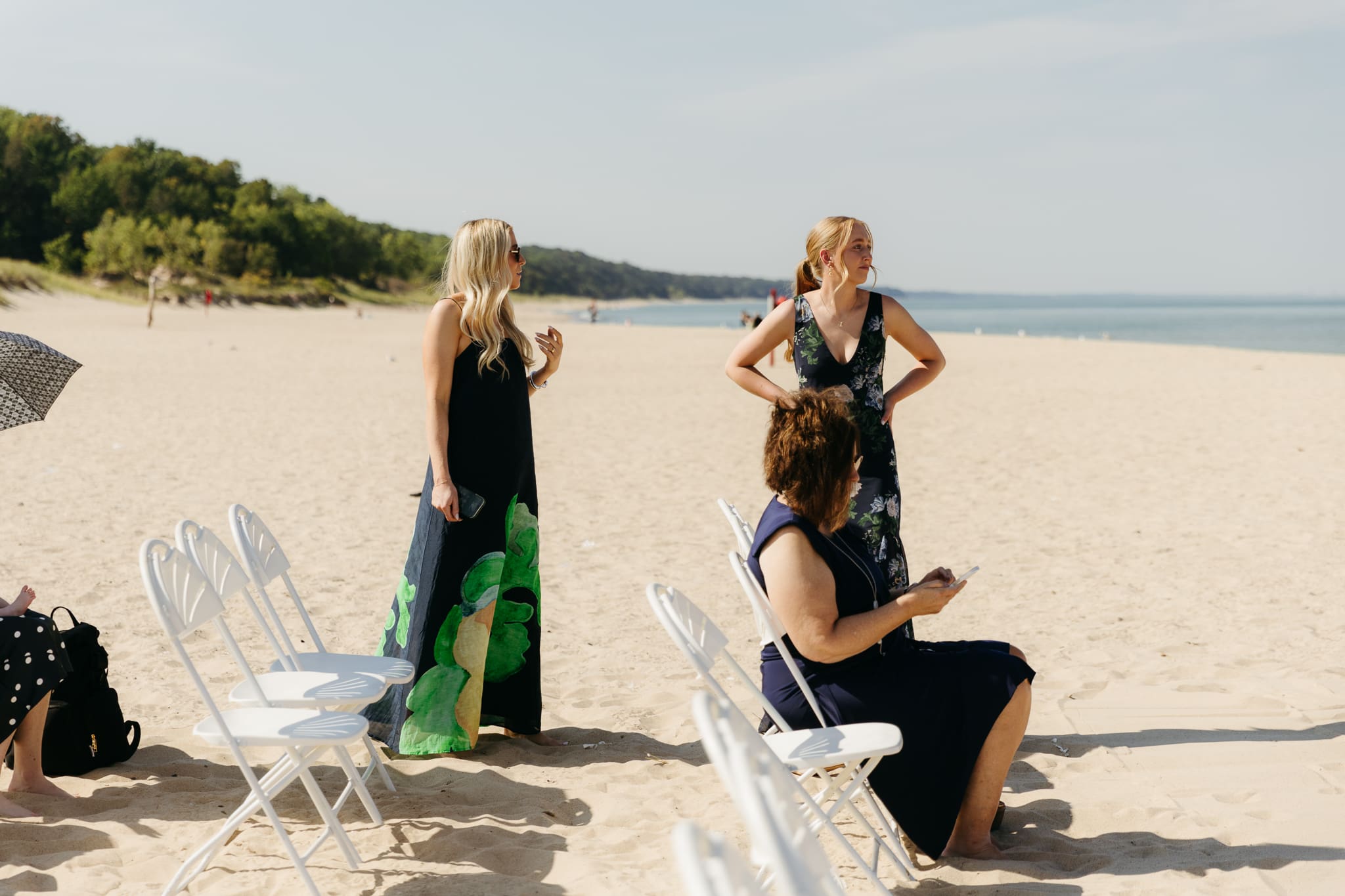Family and friends hang out and talk on the beach at Warren Dunes State Park, while waiting for a wedding ceremony to begin