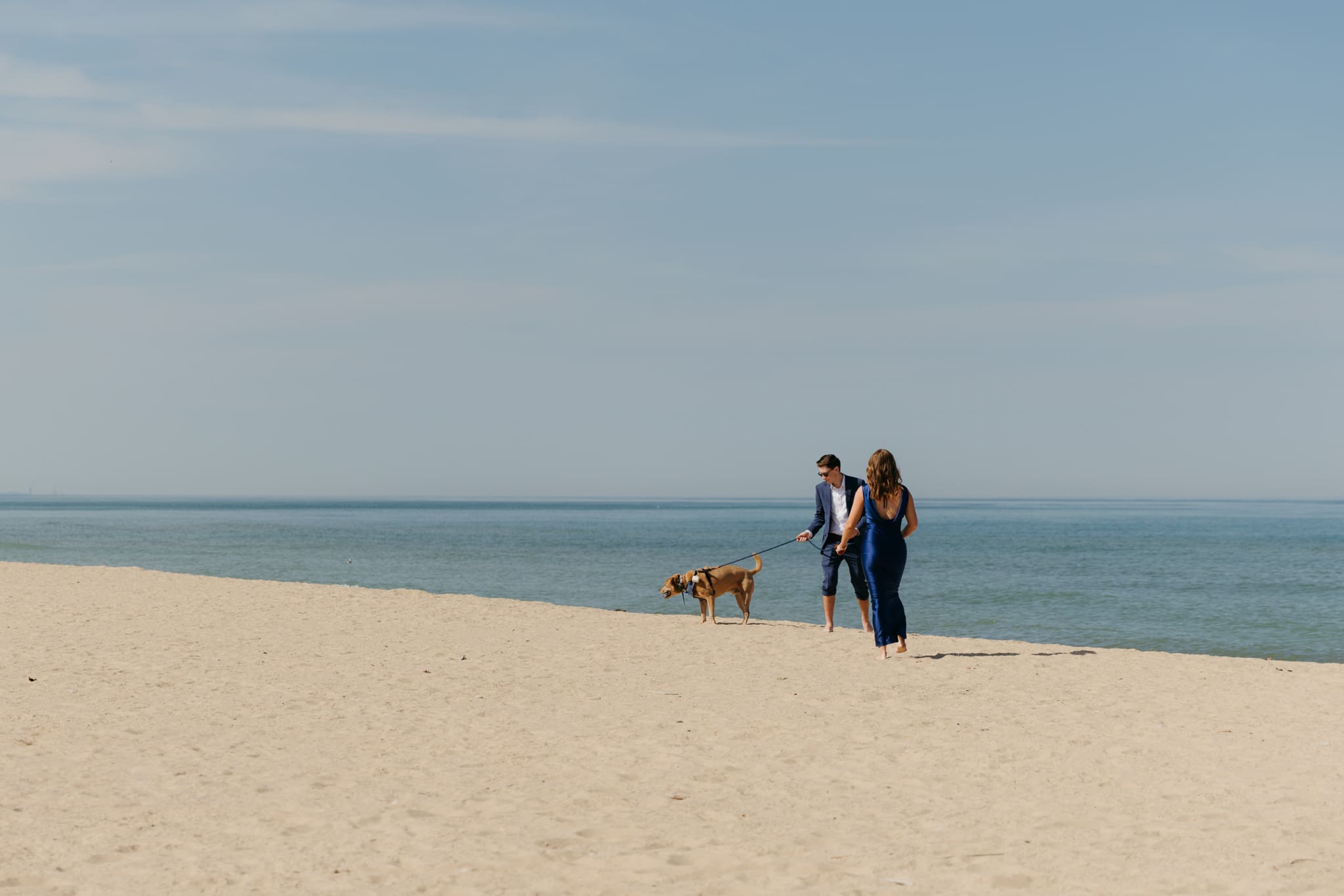 Family and friends hang out and talk on the beach at Warren Dunes State Park, while waiting for a wedding ceremony to begin