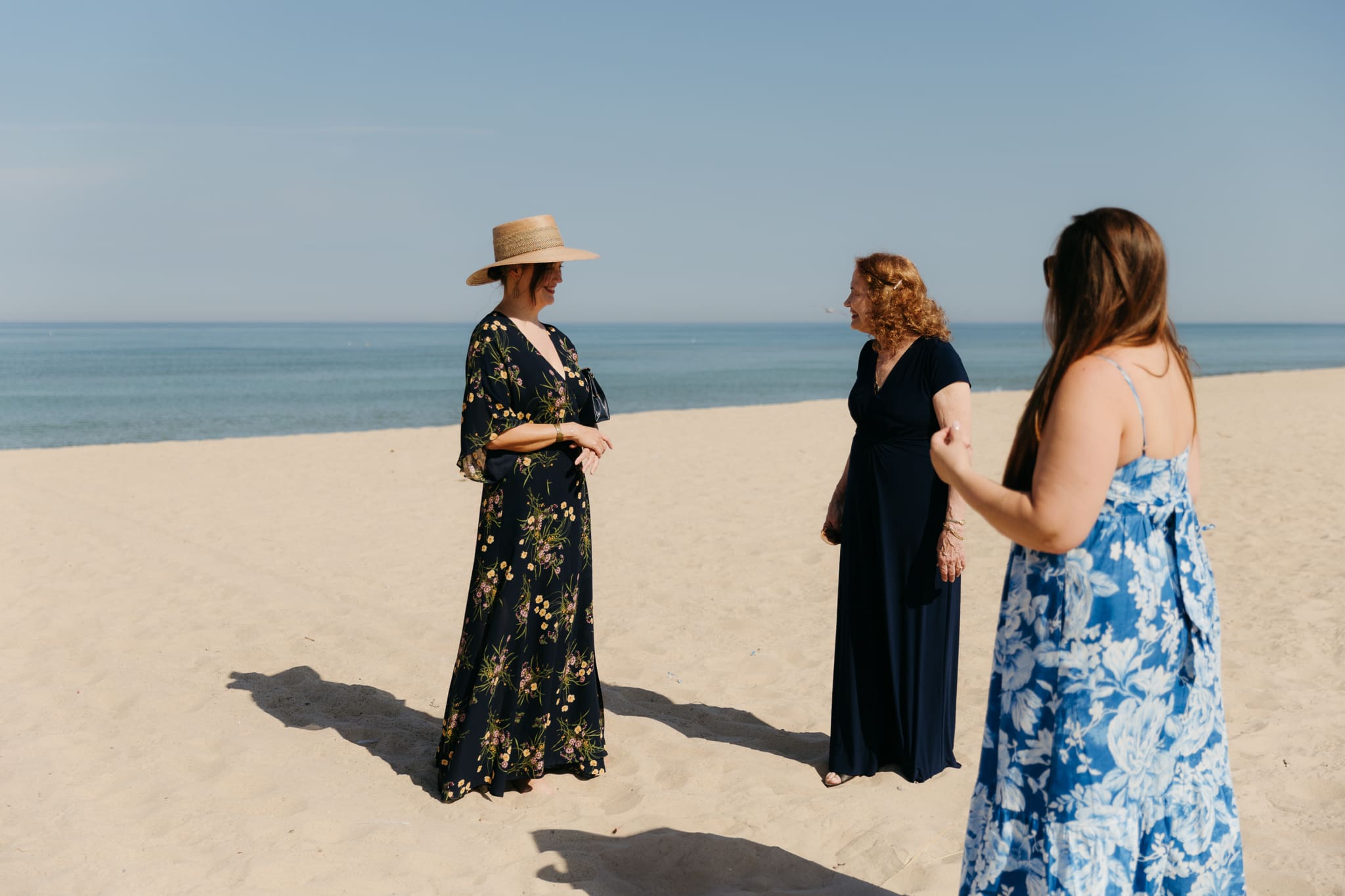 Family and friends hang out and talk on the beach at Warren Dunes State Park, while waiting for a wedding ceremony to begin