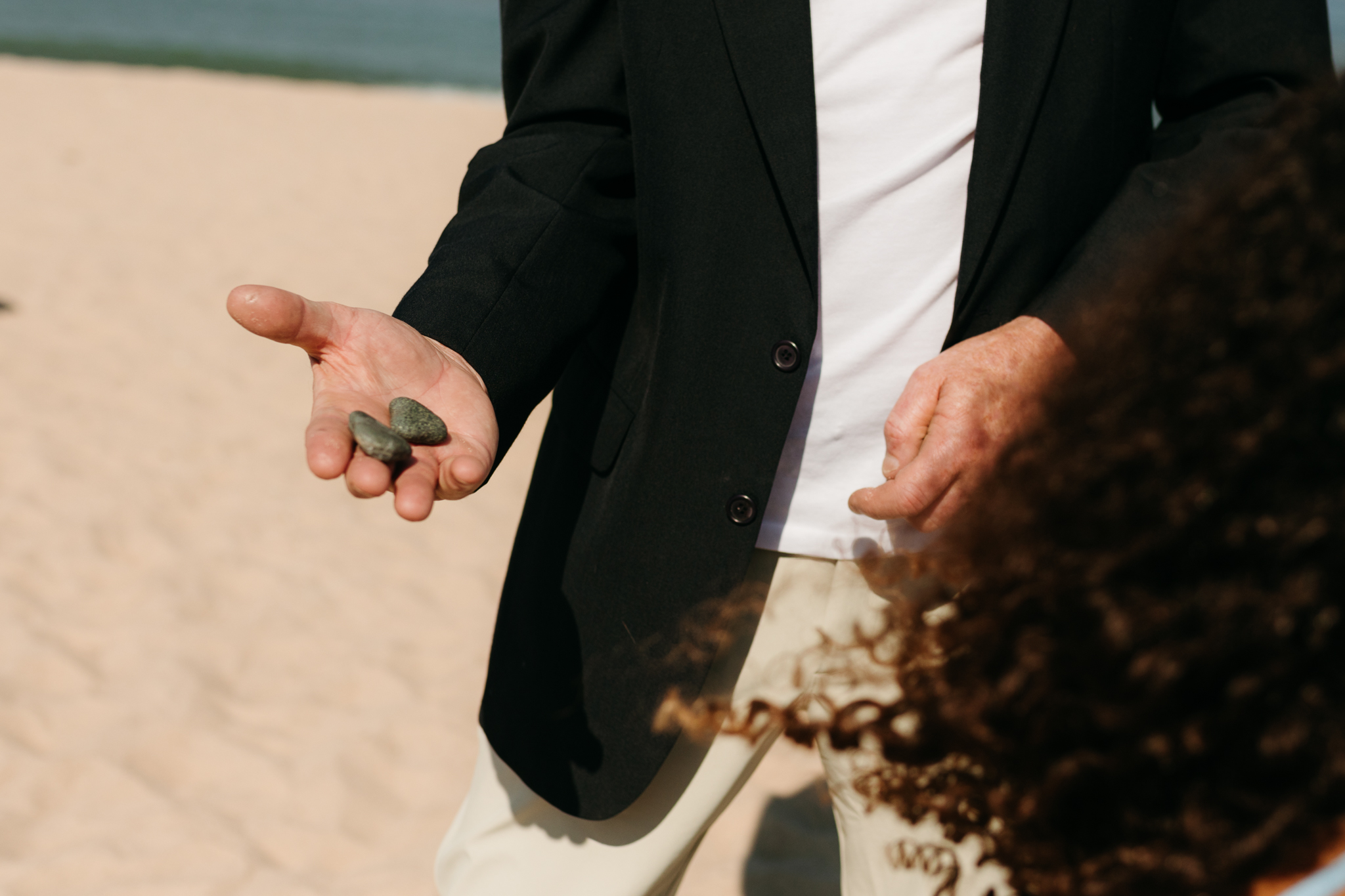 Family and friends hang out and talk on the beach at Warren Dunes State Park, while waiting for a wedding ceremony to begin