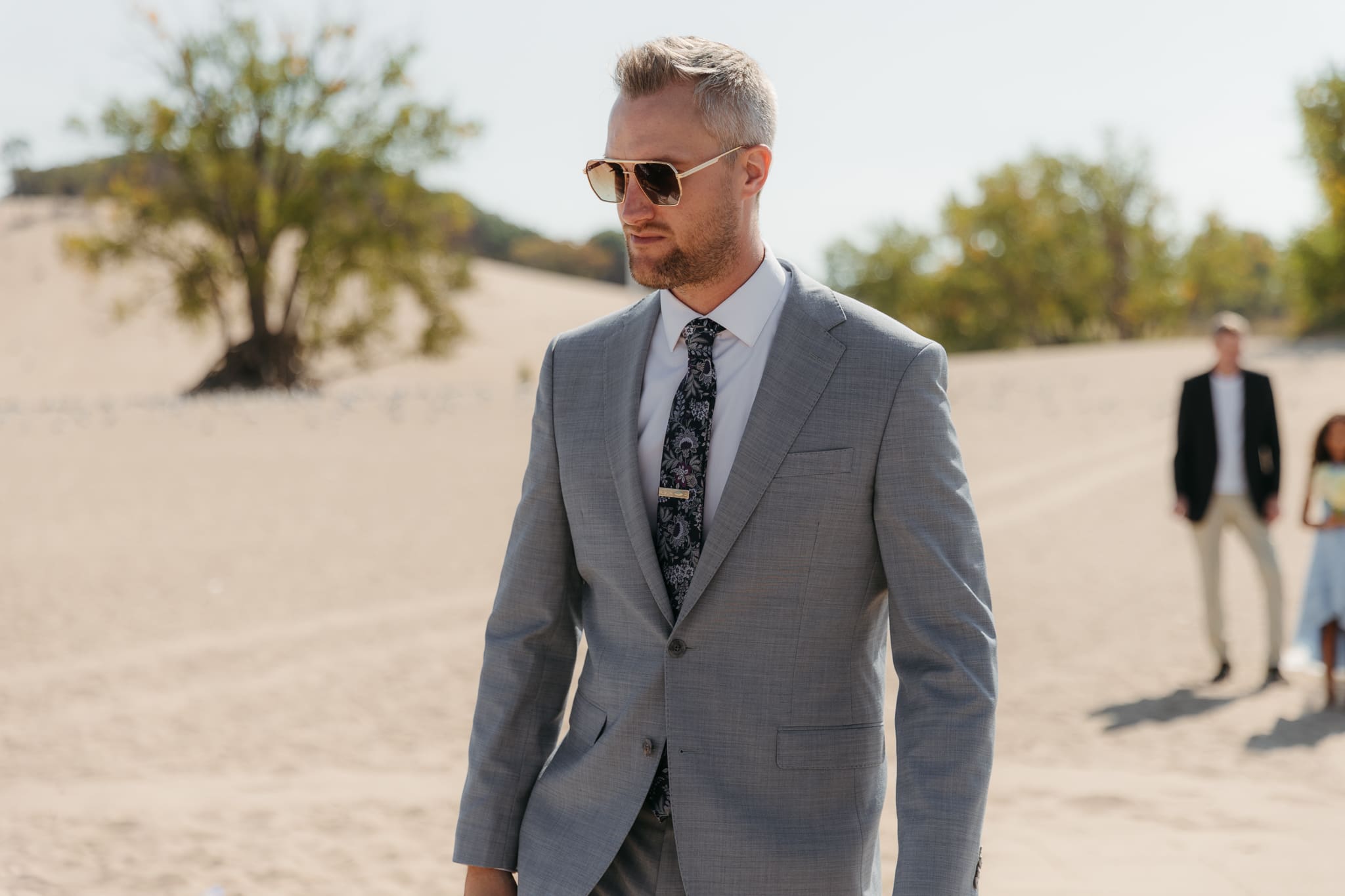 Groom walks down the aisle during a beach wedding ceremony at Warren Dunes State Park