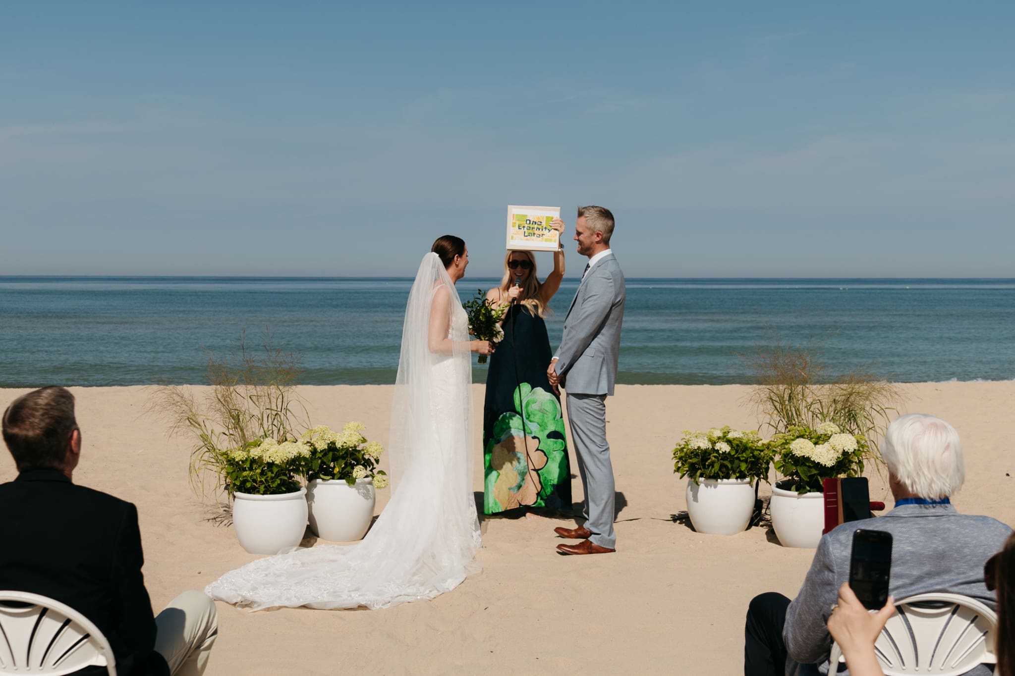 Bride and groom exchange vows on the beach during their Lake Michigan wedding ceremony at Warren Dunes State Park