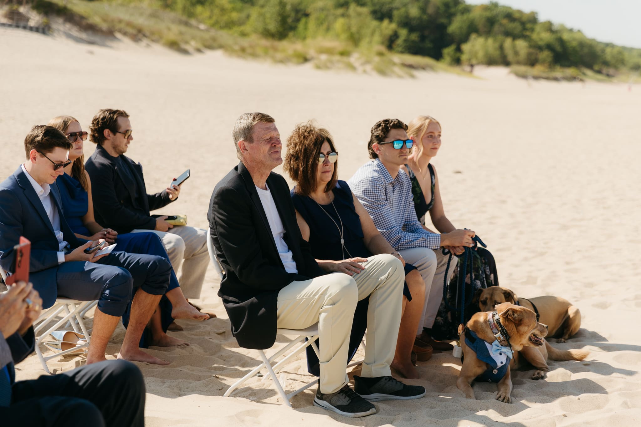Bride and groom exchange vows on the beach during their Lake Michigan wedding ceremony at Warren Dunes State Park