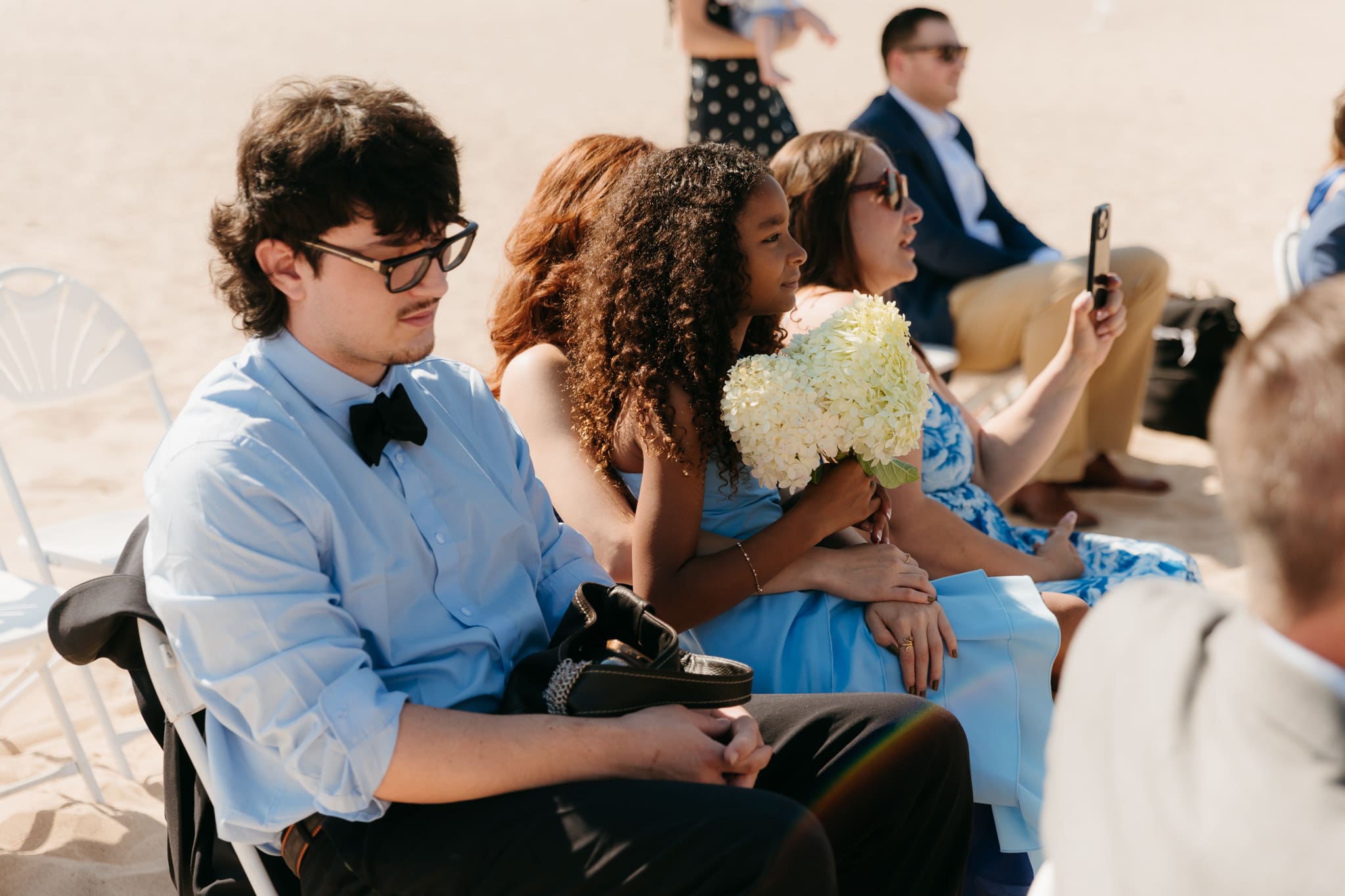 Bride and groom exchange vows on the beach during their Lake Michigan wedding ceremony at Warren Dunes State Park