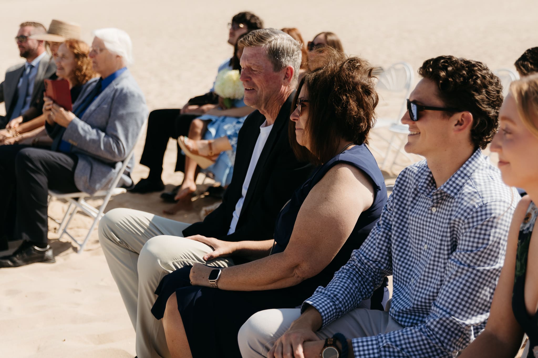 Bride and groom exchange vows on the beach during their Lake Michigan wedding ceremony at Warren Dunes State Park