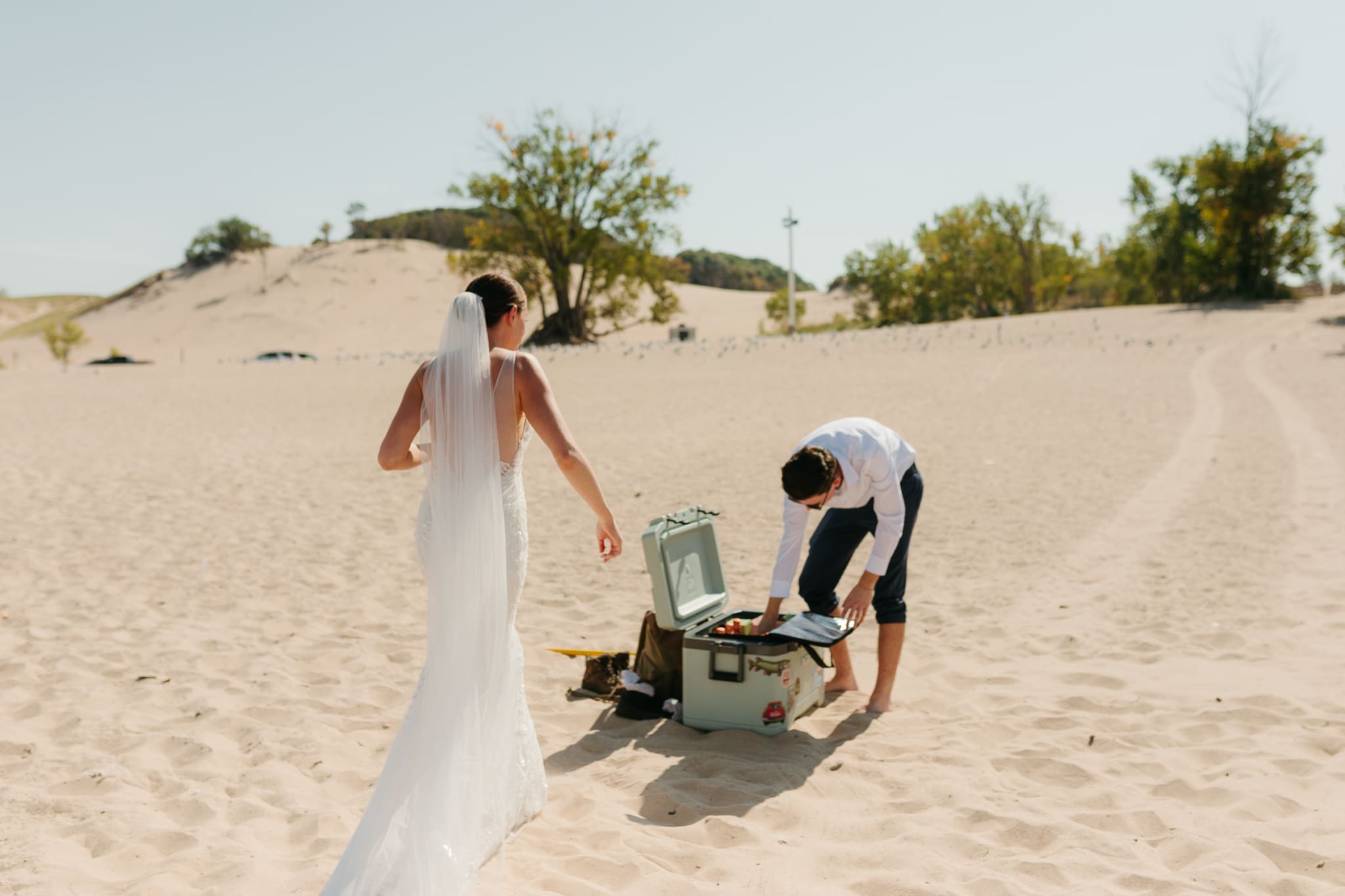 Wedding guests mingling during a beach elopement at Warren Dunes State Park