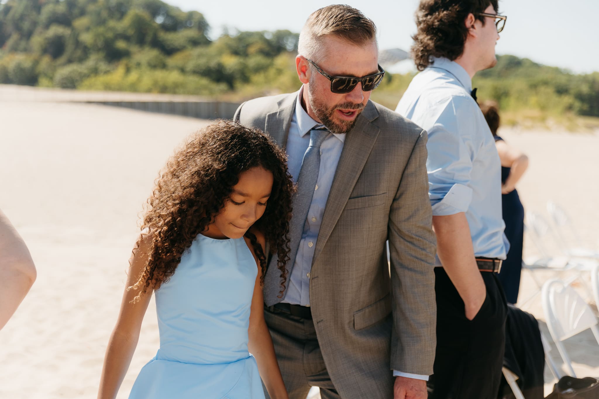 Wedding guests mingling during a beach elopement at Warren Dunes State Park