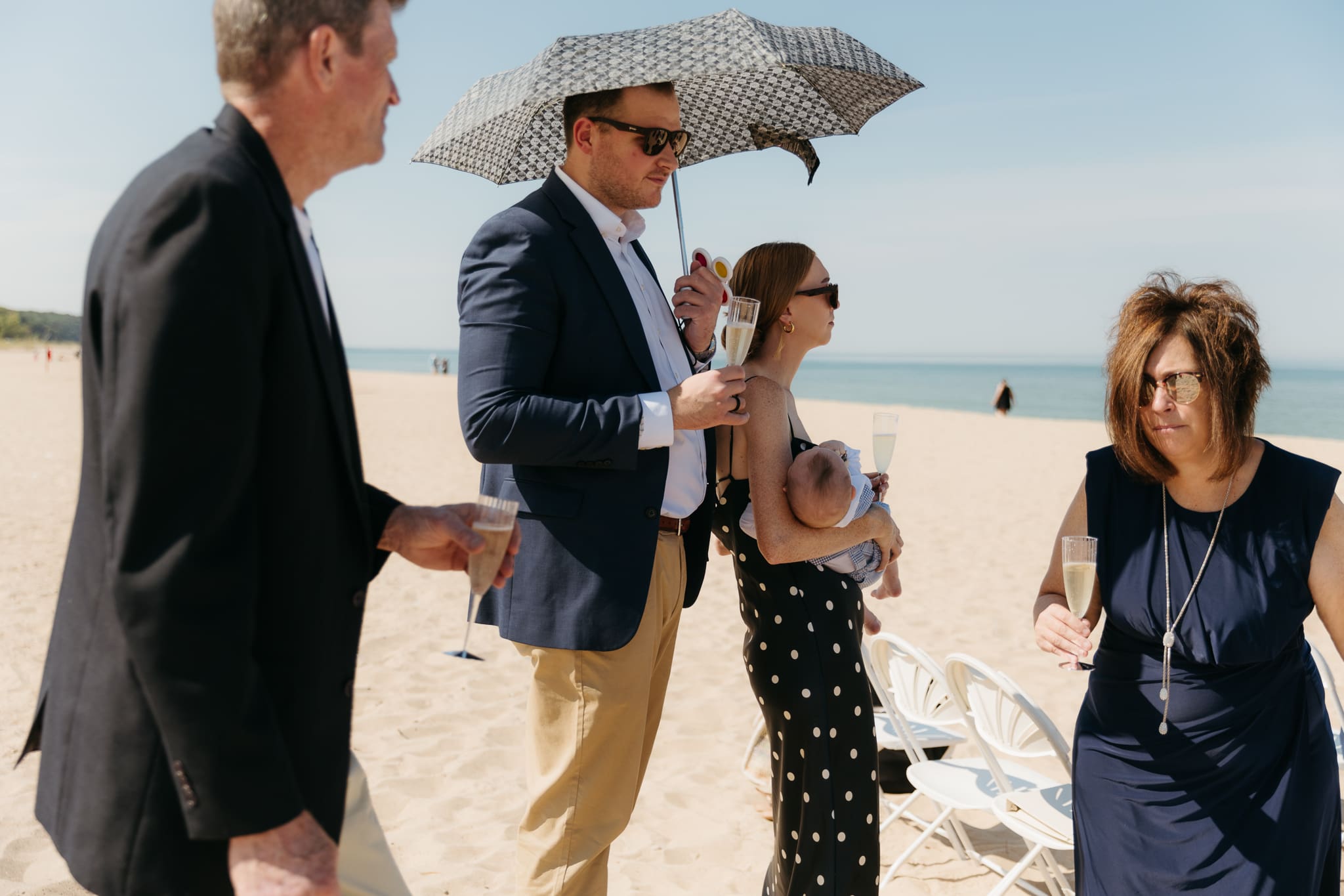 Wedding guests mingling during a beach elopement at Warren Dunes State Park