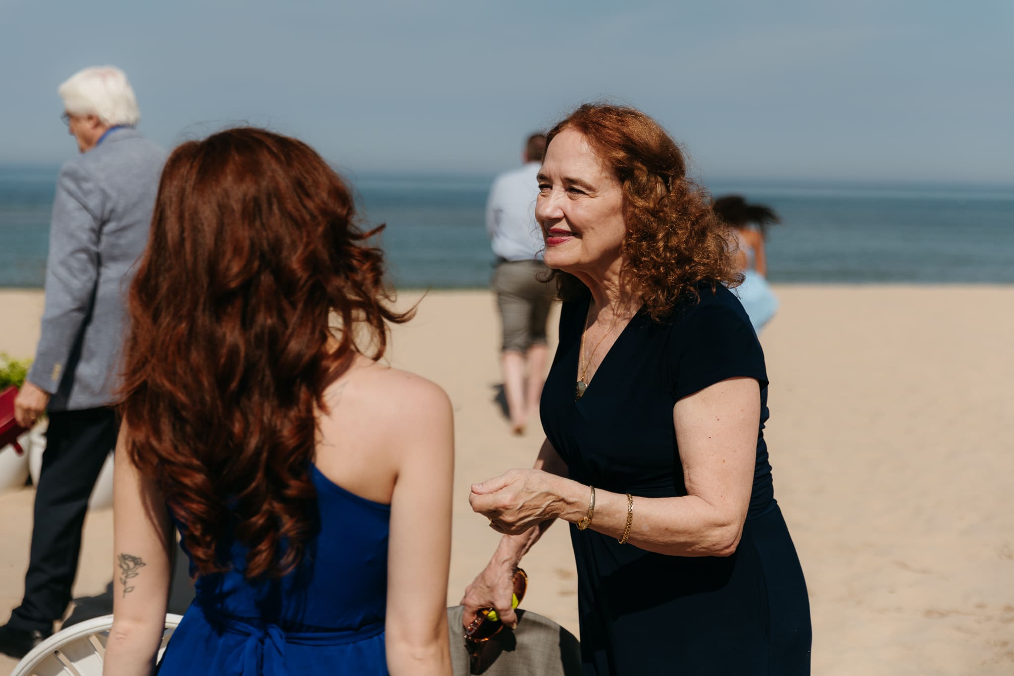 Wedding guests mingling during a beach elopement at Warren Dunes State Park
